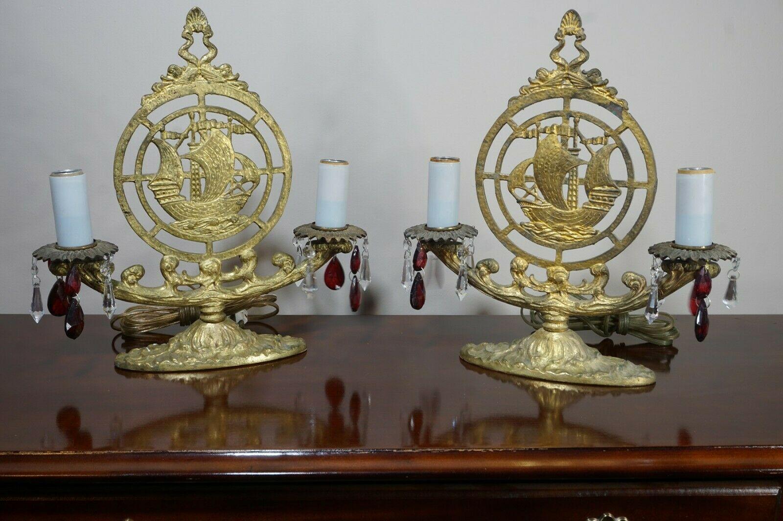 Beautiful Pair of Art Deco Bronze Nautical Ship Table Lamps. Crystal adorned. One ship faces right and one ship faces left.