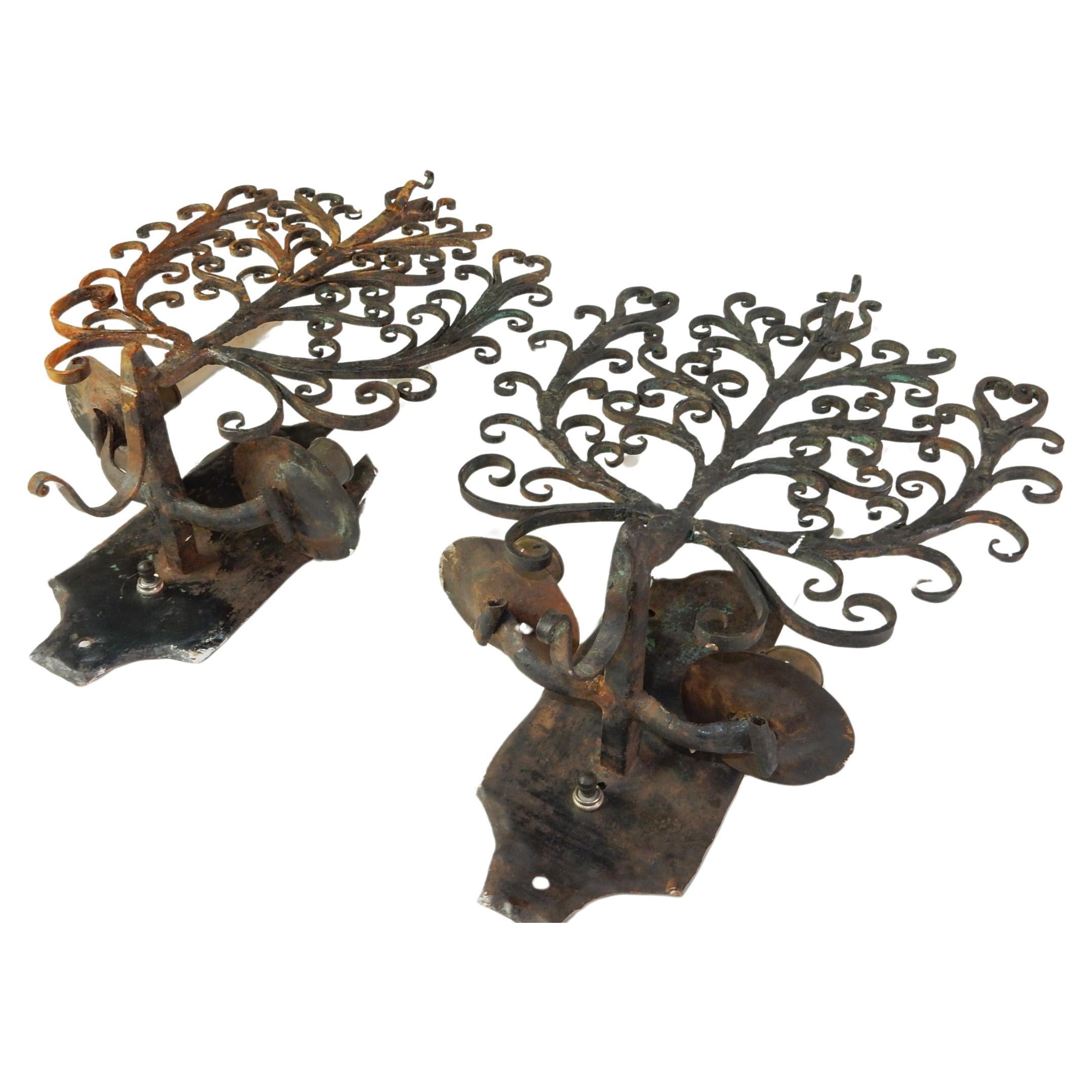 Here is an original pair of artistically sculpted iron wall sconces.
Circa 1920's. Not signed or marked, they look to be completely hand crafted.
Requires 2 candle base bulbs. 