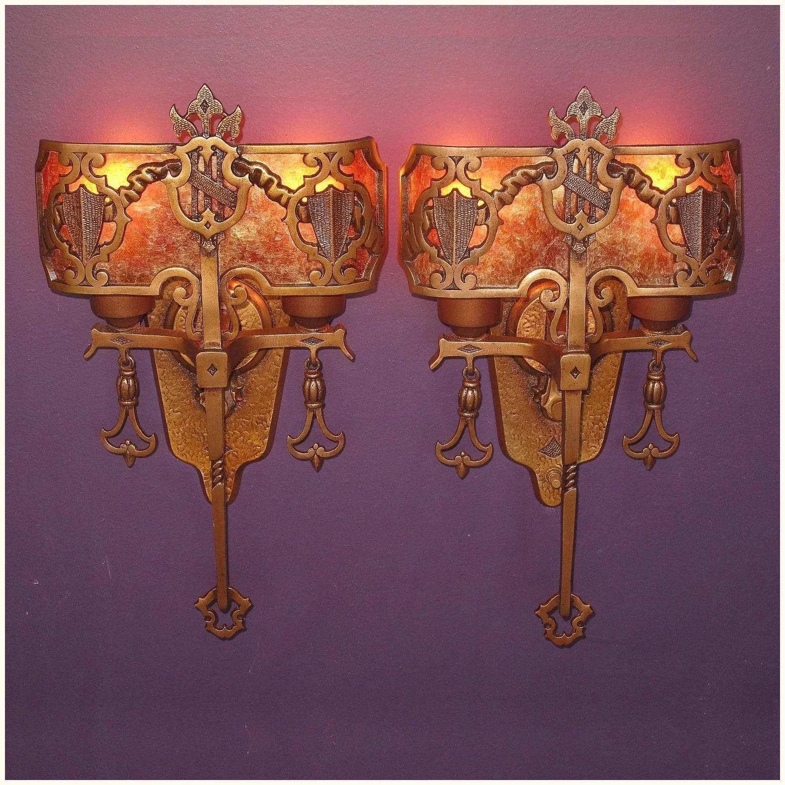 Priced per pair.
Solid bronze 2 bulb Tudor / Spanish Revival style vintage 1920s wall sconces. Renewed finish and light bulbs have a new amber mica shade. Nice complement to any Spanish Revival, Gothic, or Tudor home.
Bronze casting is still sharp