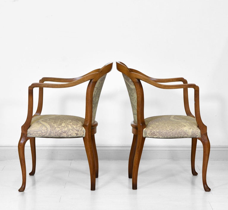 A superb pair of elegant Art Deco walnut framed upholstered open armchairs. Stamped 