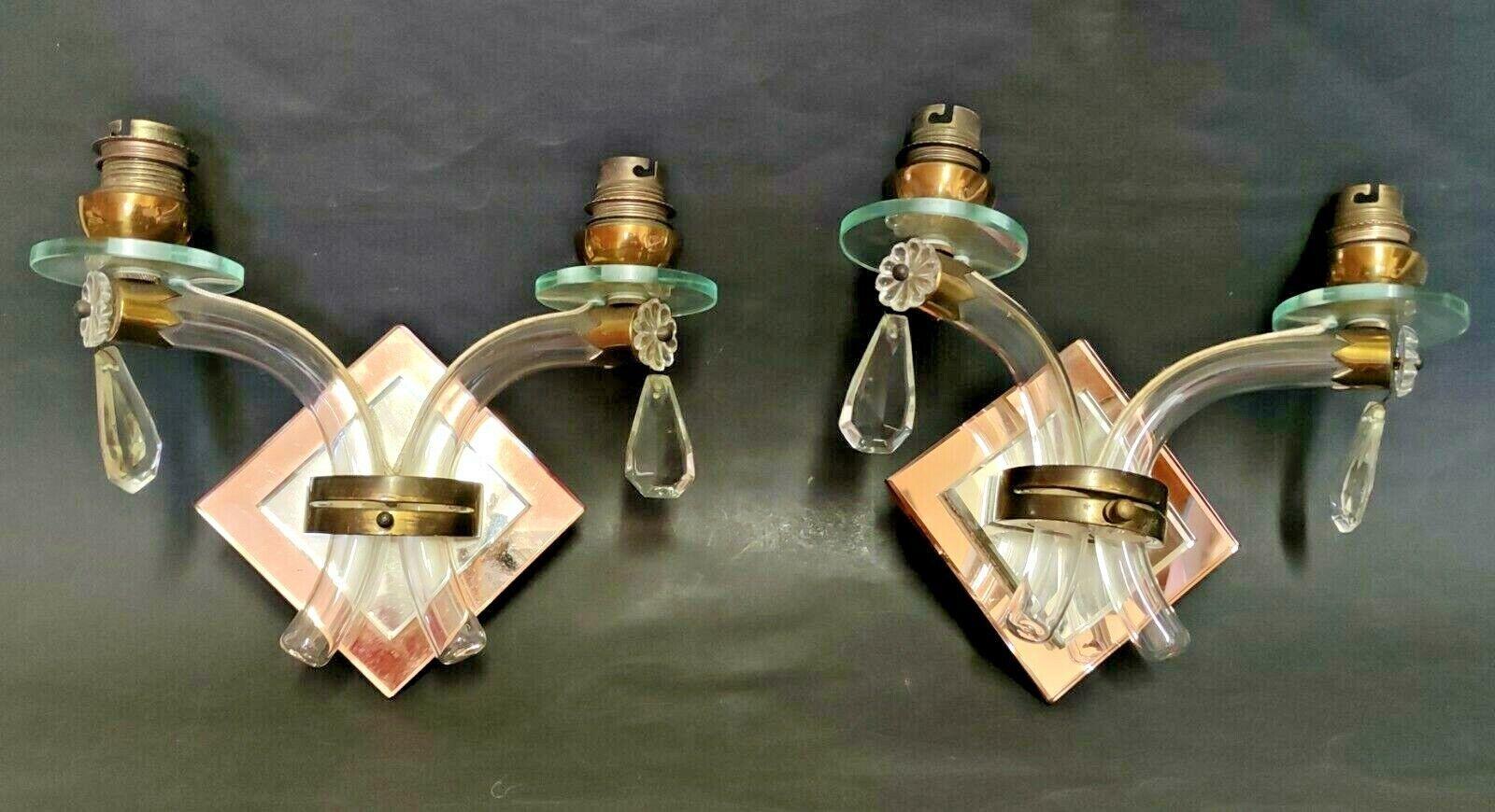 Pair 1930's French Art Deco Crystal Wall Sconces style Jules Leleu. Crystal tubular form adorned with Cut Crystal. Pink and clear mirror back. Wood backed and very beautiful!