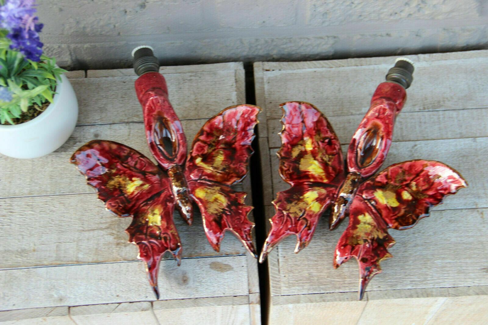 Beautiful Pair of French Art Deco Patinated and Glazed Ceramic Butterfly Wall Sconces. Stunning color. Would be great anywhere in the home where accent lighting is desired. The childrens room would make a good home for this rare pair of wall lights.