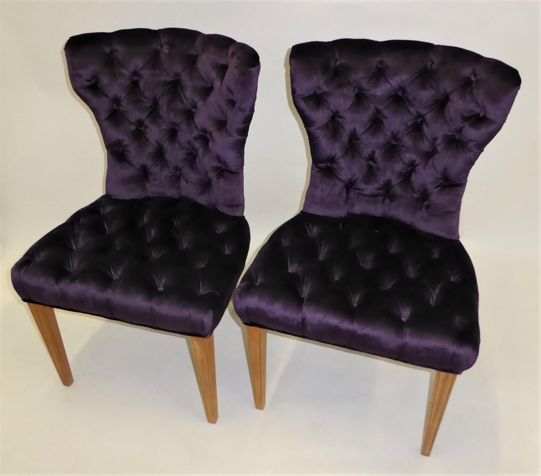 Beautifully styled with winged shoulders, this pair of 1930 deep tufted slipper chairs newly re-upholstered in royal purple velvet fabric are superb and solid side chairs. With original spring & horsehair upholstery and additional modern upholstery