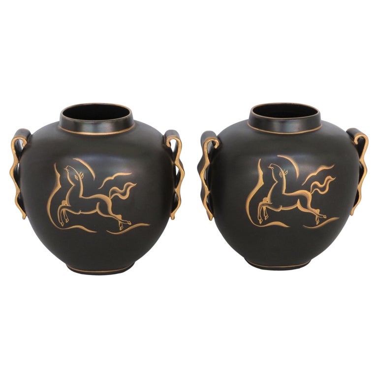 Exquisite Art Deco Vases, designed by Charles Catteau (1880-1966), executed by Boch Frères Keramis, Belgium. Matte black with gold hand painted spirited horse on the front and a stylized tulip on the back. Gilt edge wave handles on the sides and