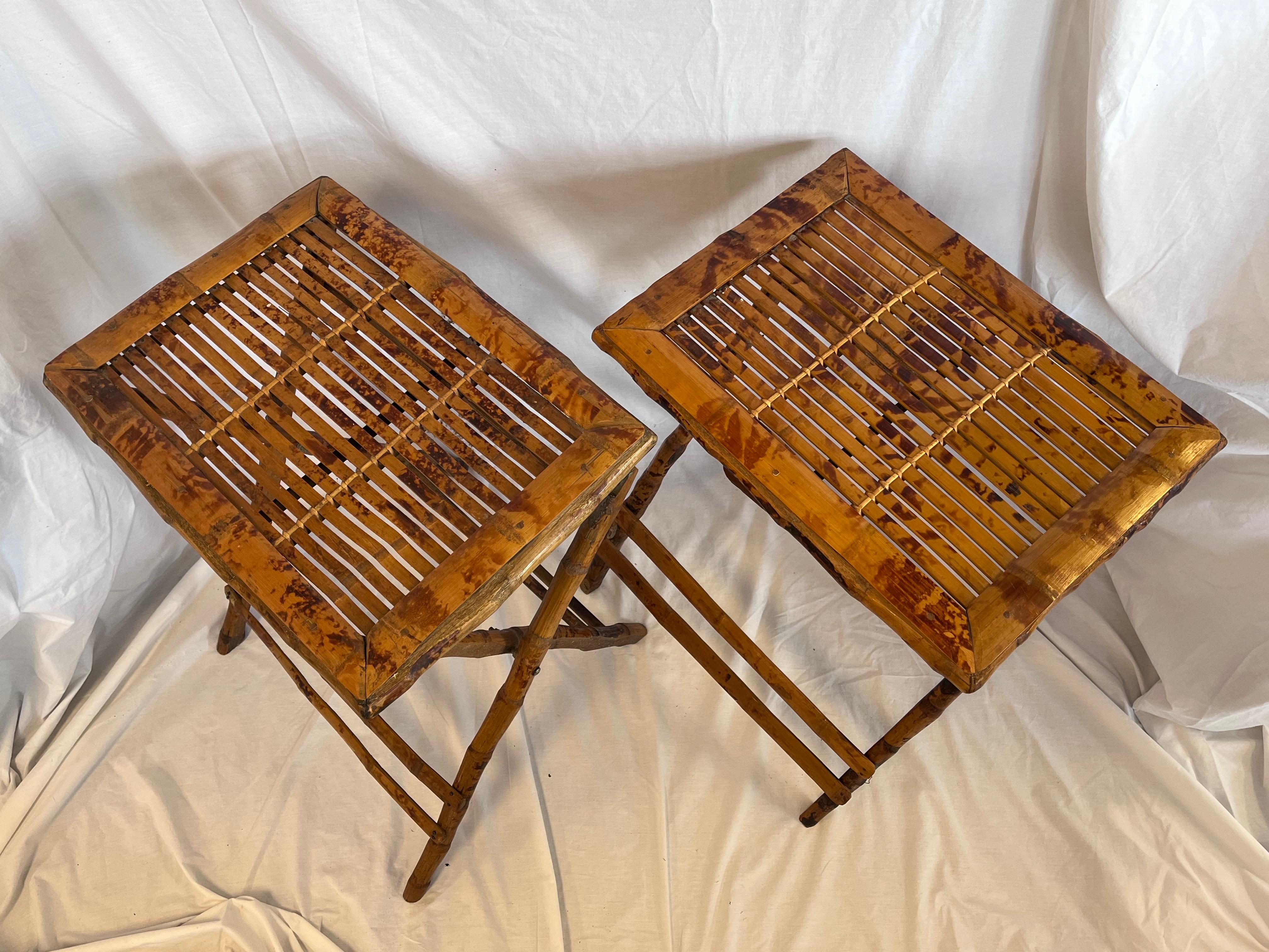 A pair of circa 1940's tortoise bamboo folding tray tables. This pair of mid century tables could also be used as end or side tables as well as nightstands. The tortoise pattern on the bamboo is truly beautiful and adds a very special flair to the
