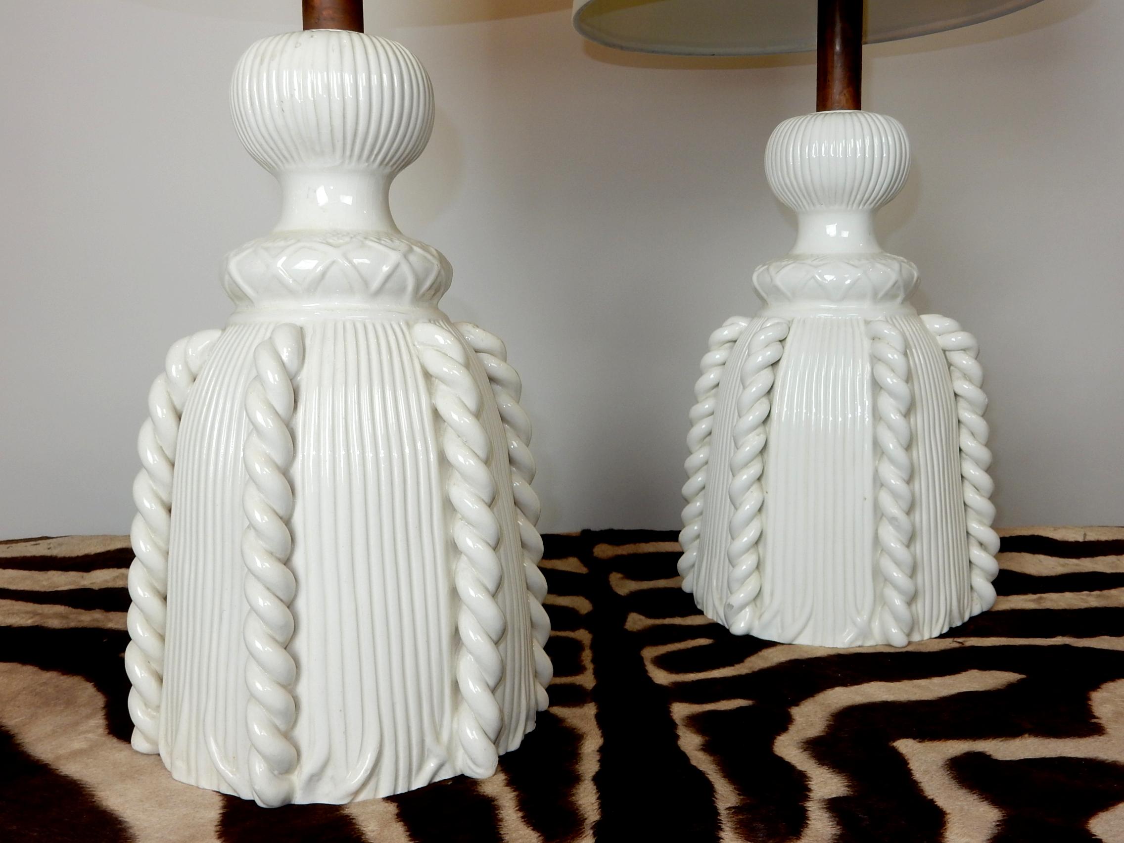 Gorgeous porcelain rope tassel sculpture table lamps with glossy blanc de chine white glaze! 
Both signed Bassenello on inside. Aged copper top. 
Brass Asian motif finials included(shades not included).
 