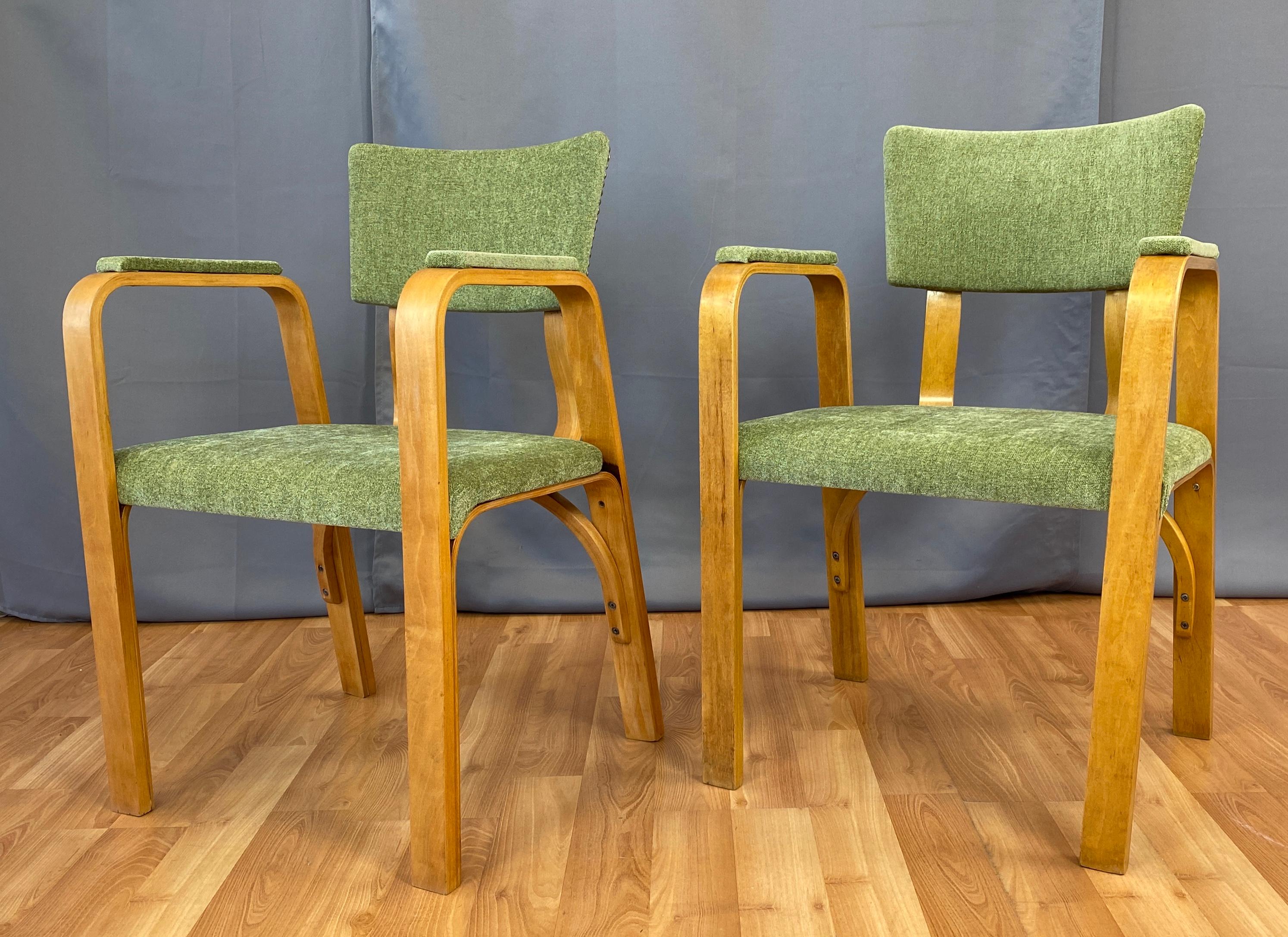 Offered here is a handsome pair of circa 1950s arm chairs by Thonet.
Bentwood frame, with new cotton blend upholstery, nail head detailing on backrest. 
Chairs frames look to have been recently refinished.