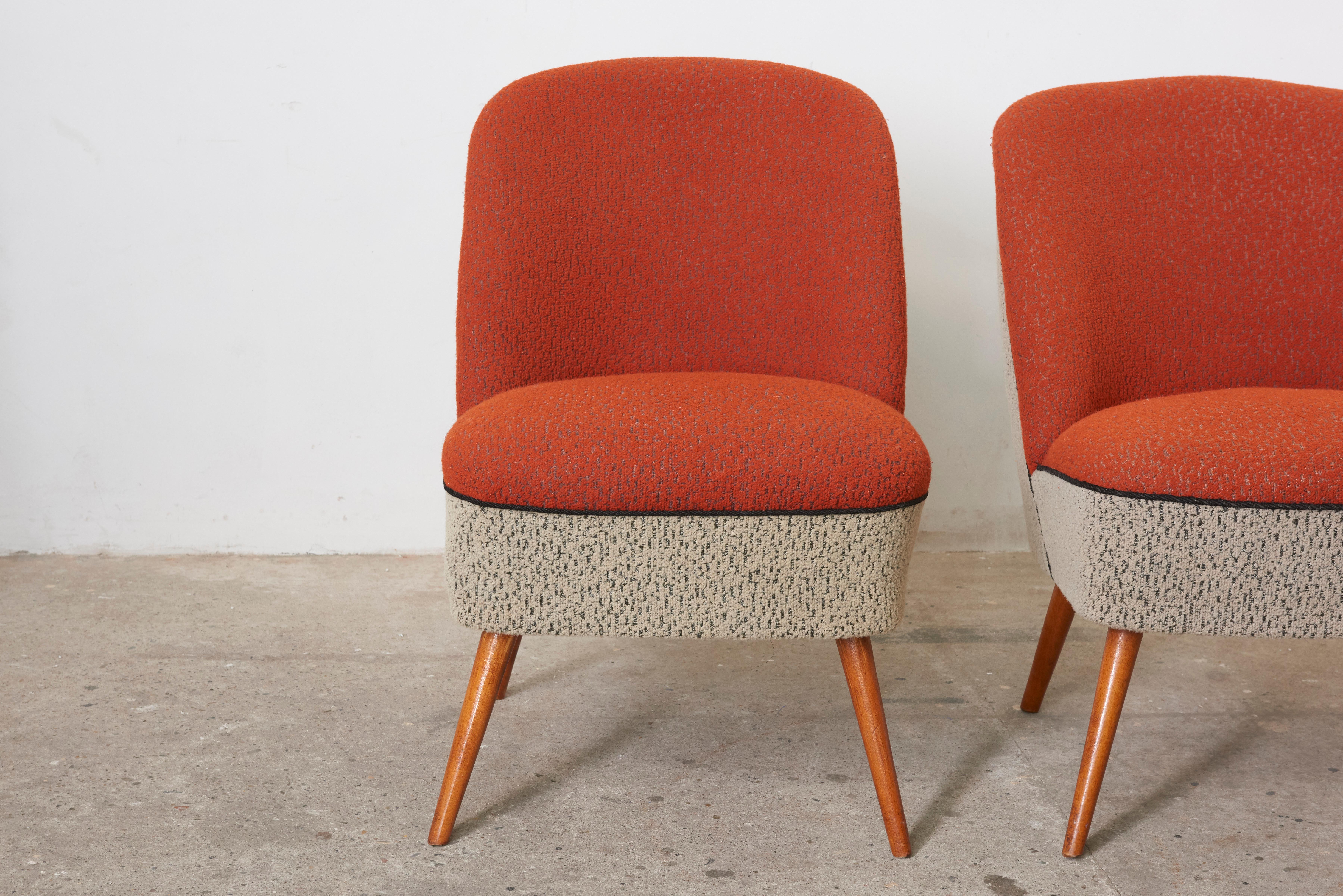 These Cocktail Chairs were originally produced in Switzerland in the 1950s and have typical tapered legs and a plain curved back that hugs you as you recline.
These chairs are charming in the original 1950s upholstered colored wool in red,white and