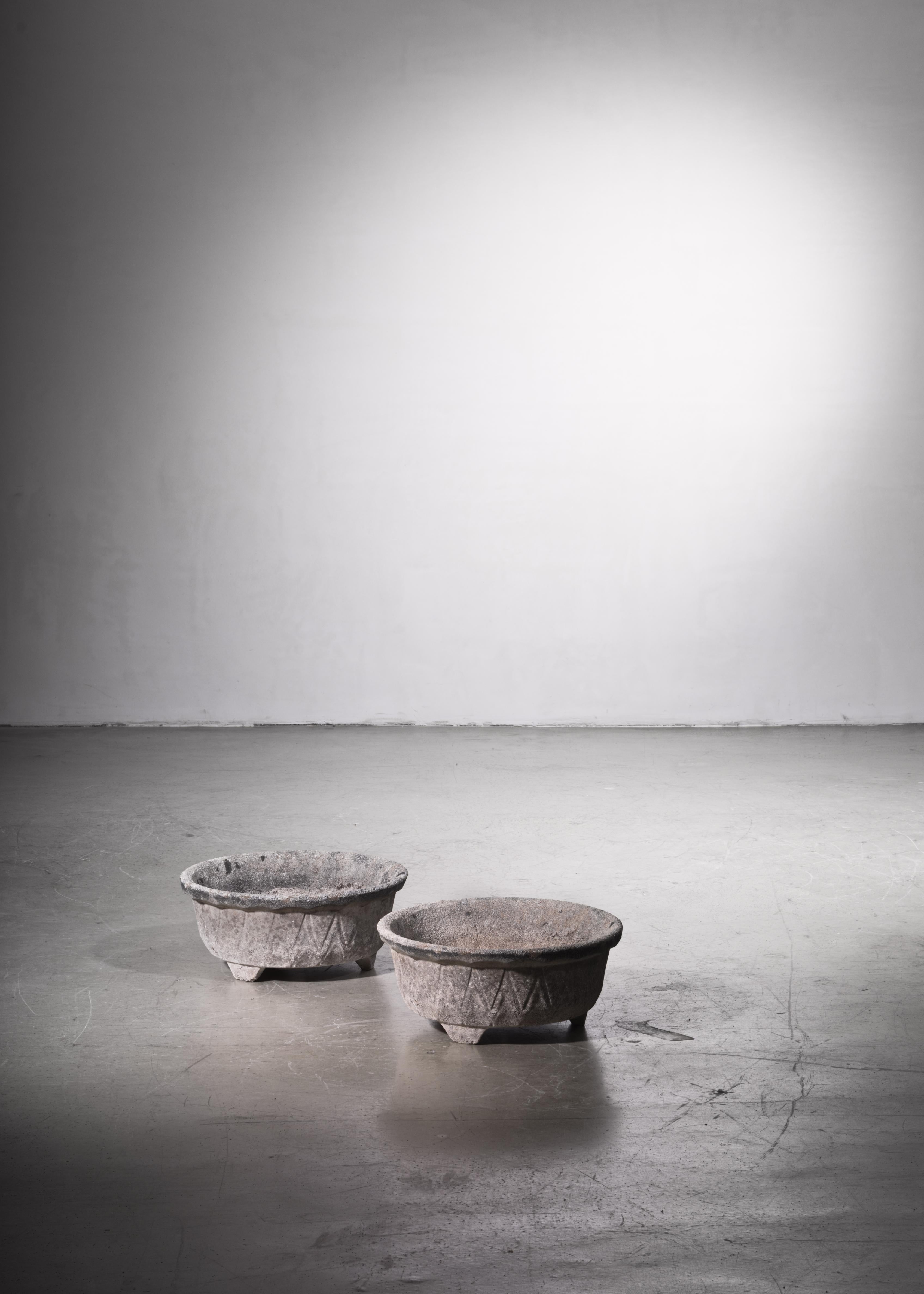 A beautiful pair of stone garden pots from France with the patina and character of a time-worn object.