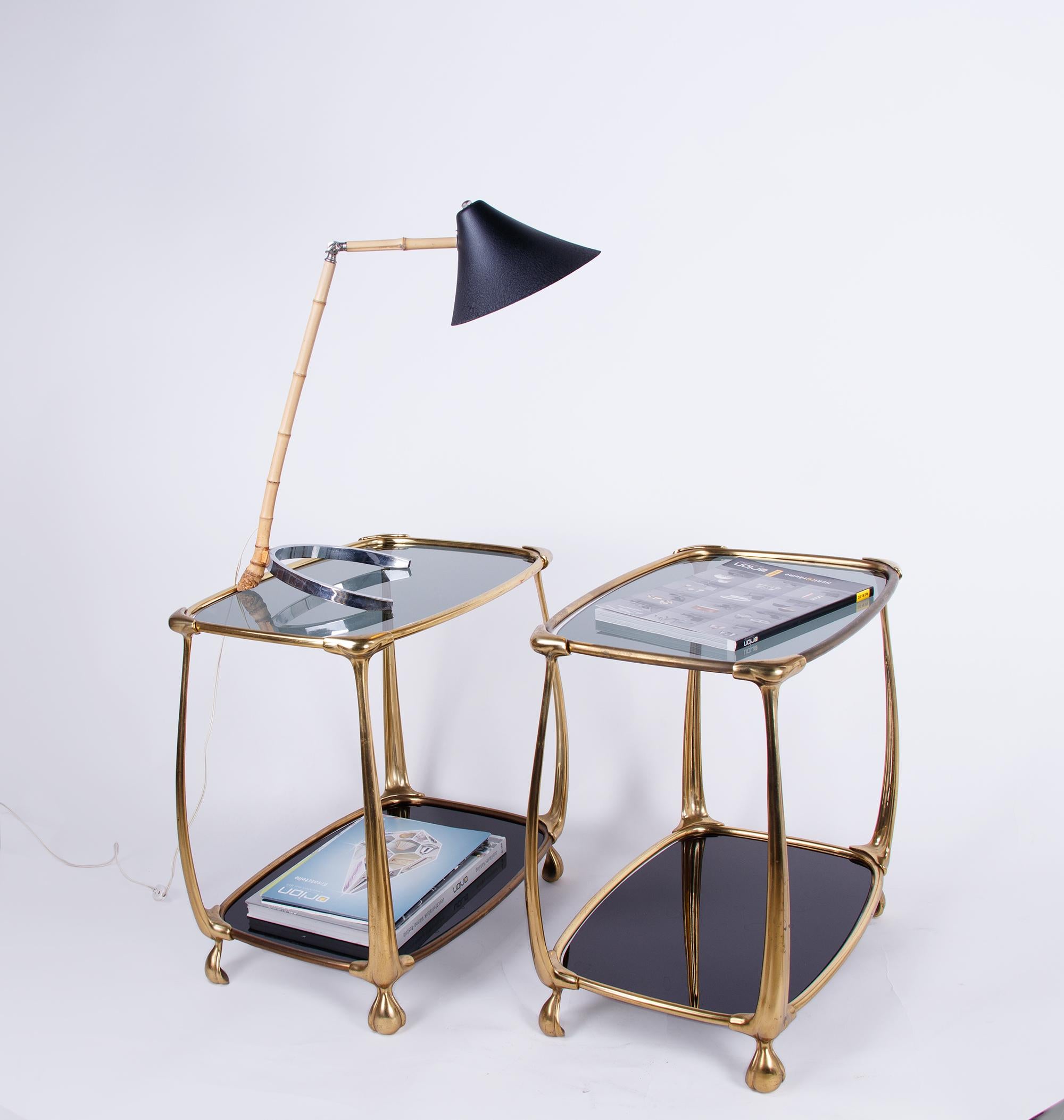 A rare pair of Italian design side tables with two tiers of smoked and black glass resting on curved brass legs. 

These Impressive side tables were made in Italy in the 1960s. Unknown Maker. 

Measures: appr. 20.5 x 14.4 x 21.25