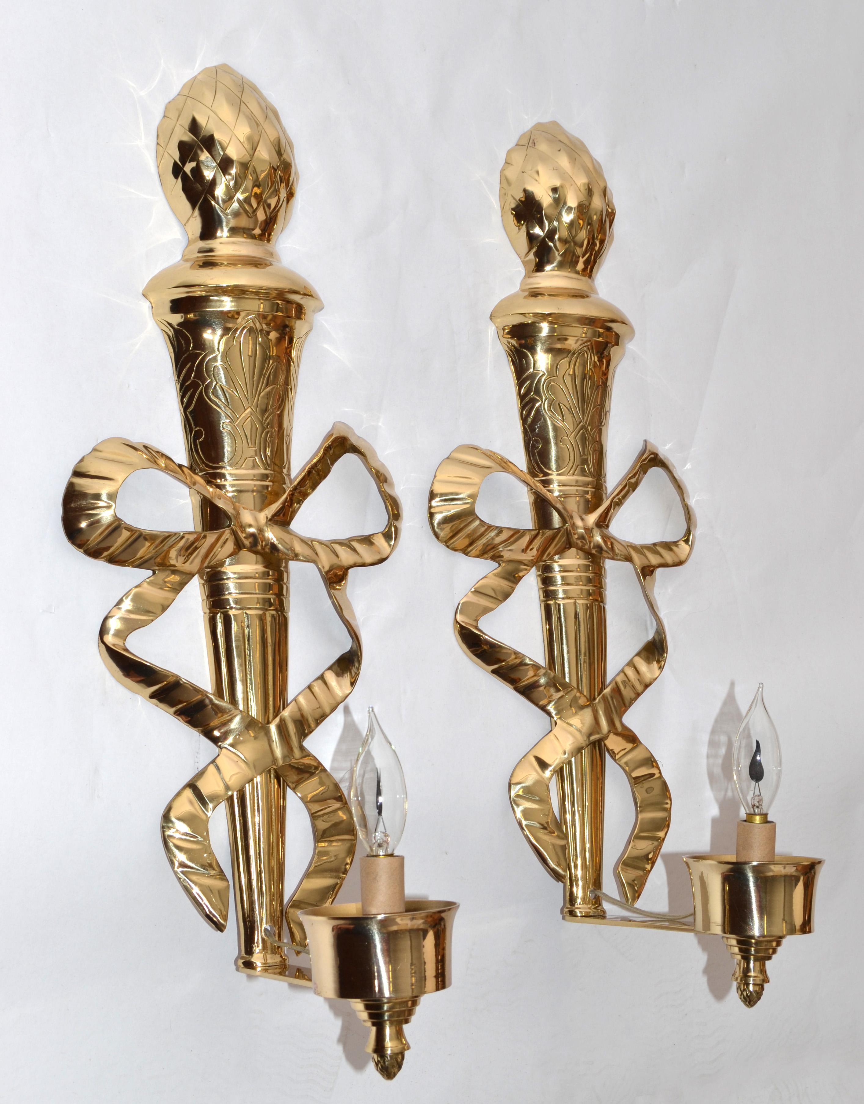 Vintage Pair of 22 inches tall ornate polished and lacquered Brass Bows with Pineapple Tops Sconces, Wall Lamps French Empire Style Brass Home Decor.
The lower portion has a central tassel swag over a fluted architectural column which ends with an