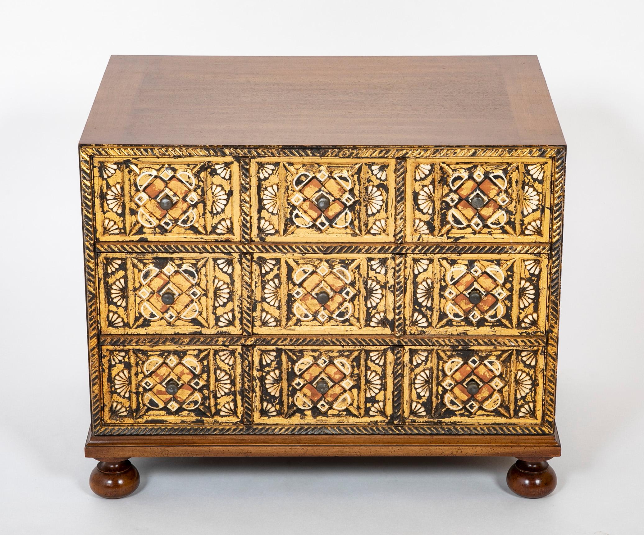 Stunning pair of John Widdicomb Spanish style bedside chests. The drawer fronts beautifully carved, painted and gilt in the style of a Spanish Baroque period vargueno. The geometric and fan motifs show the Moorish influence in early Spanish