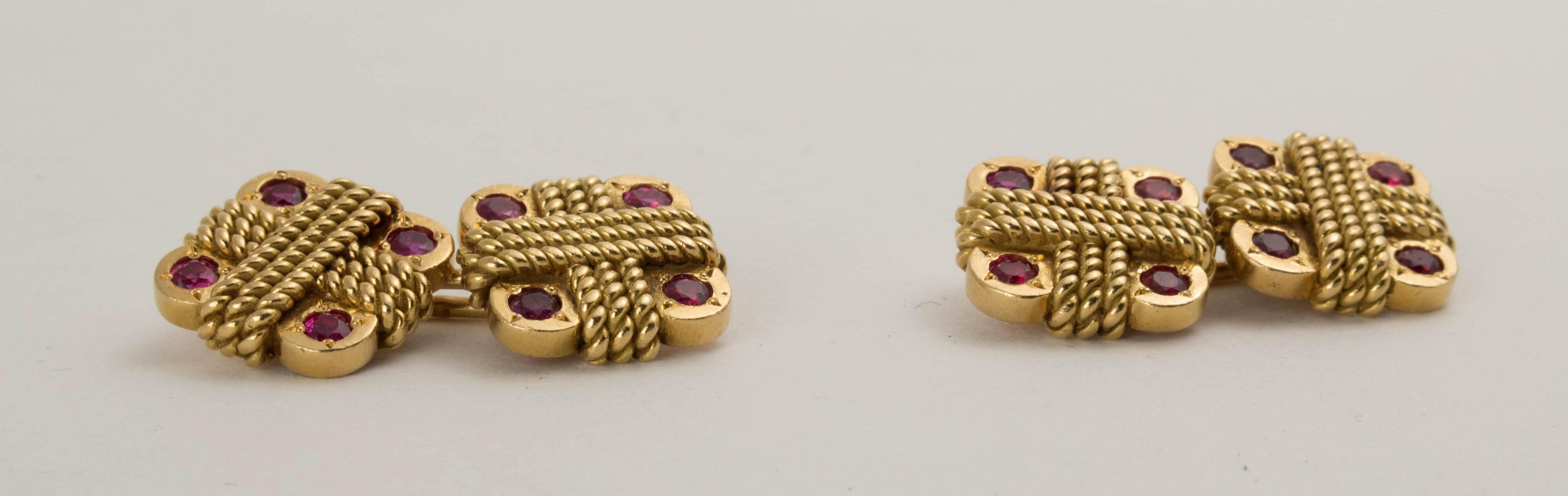 A gorgeous and elegant pair of Van Cleef and Arpels 18K yellow gold square cufflinks set with rubies, early 1960's, New York. 

The heavy gold links of square form with rounded corners. Each square quadrisected by overlapping, twisted and textured