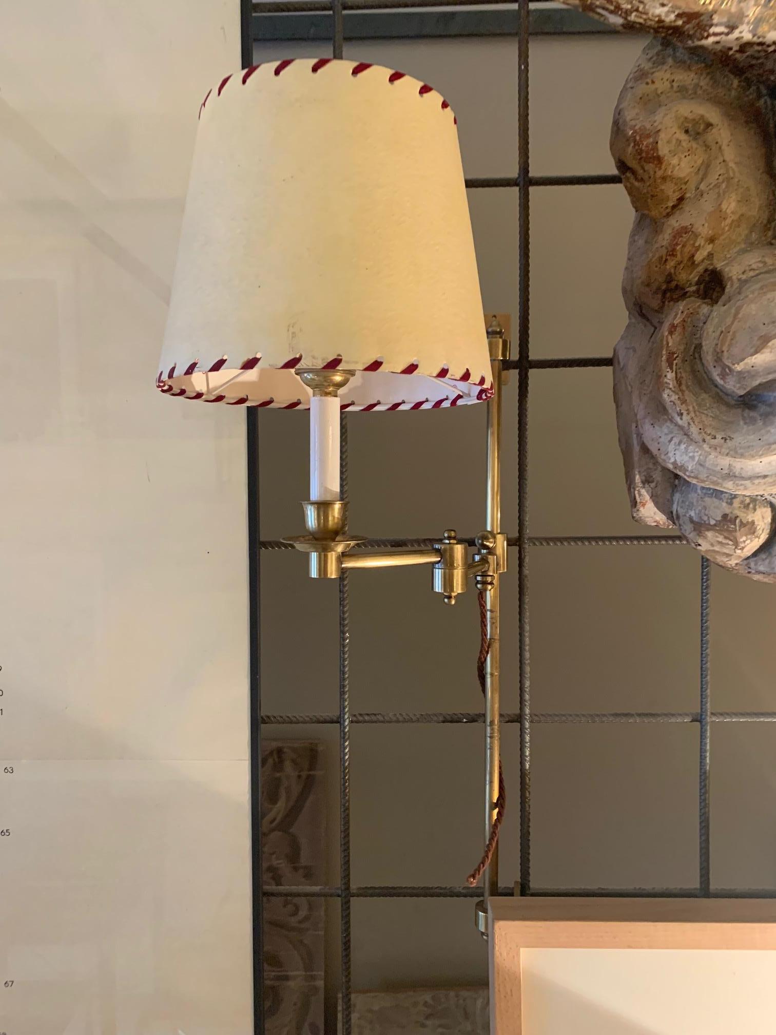 Impressive pair of very tall Spanish retractable sconces
Two-tone brass.

The sconces are retractable and also are able to swing, allowing you to adjust until you find the perfect position for your space. They come with two lampshades, the interior