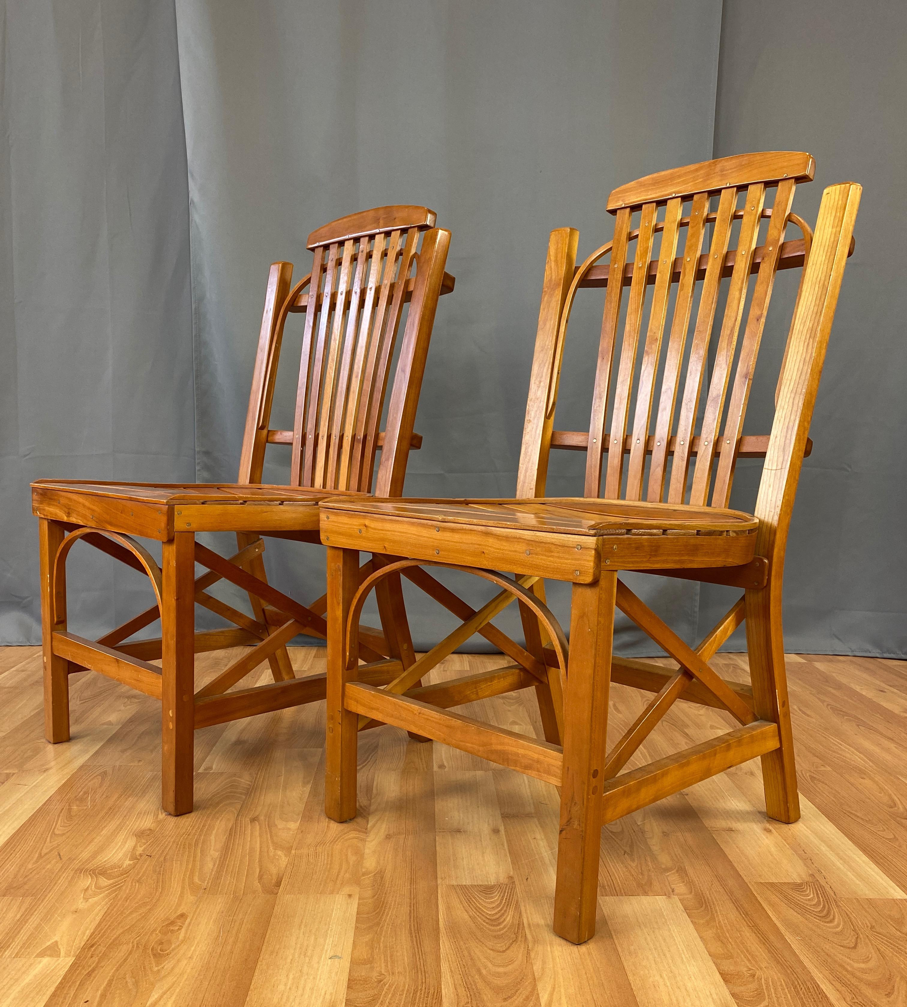 Offered here are a pair of handsome circa 1970s Amish dining or side chairs. 
Very strong and sturdy, with nice detailing, slat seat curves and holds you, backrest is also slats, with touches of bentwood. Unmarked.