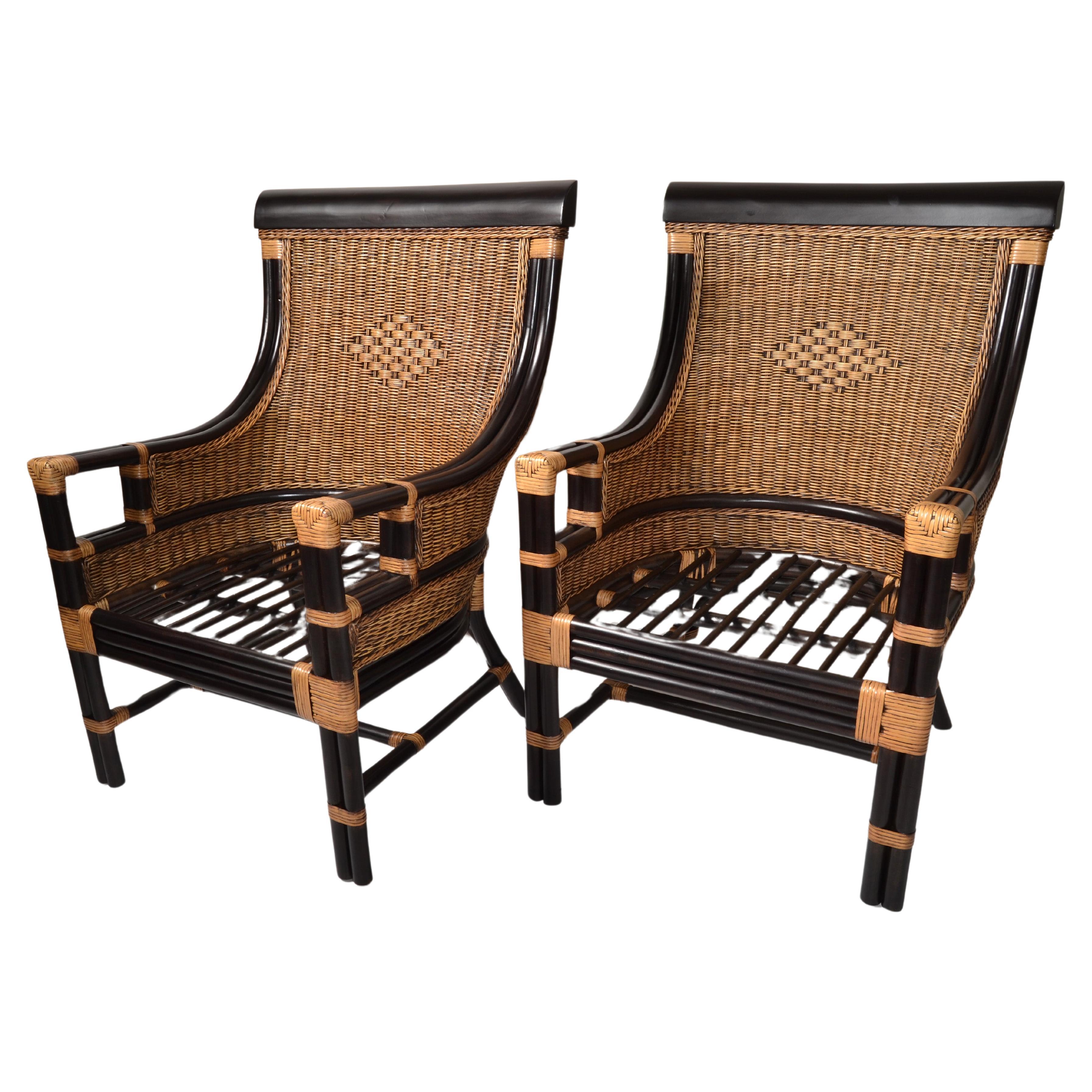 Boho Chic Mid-Century Modern large-scale ebony Bamboo and hand-woven Rattan Backrest, with an Asian inspired design.
These armchairs are constructed from durable Bamboo wood that ensures it will remain in pristine conditions for many years. 
The