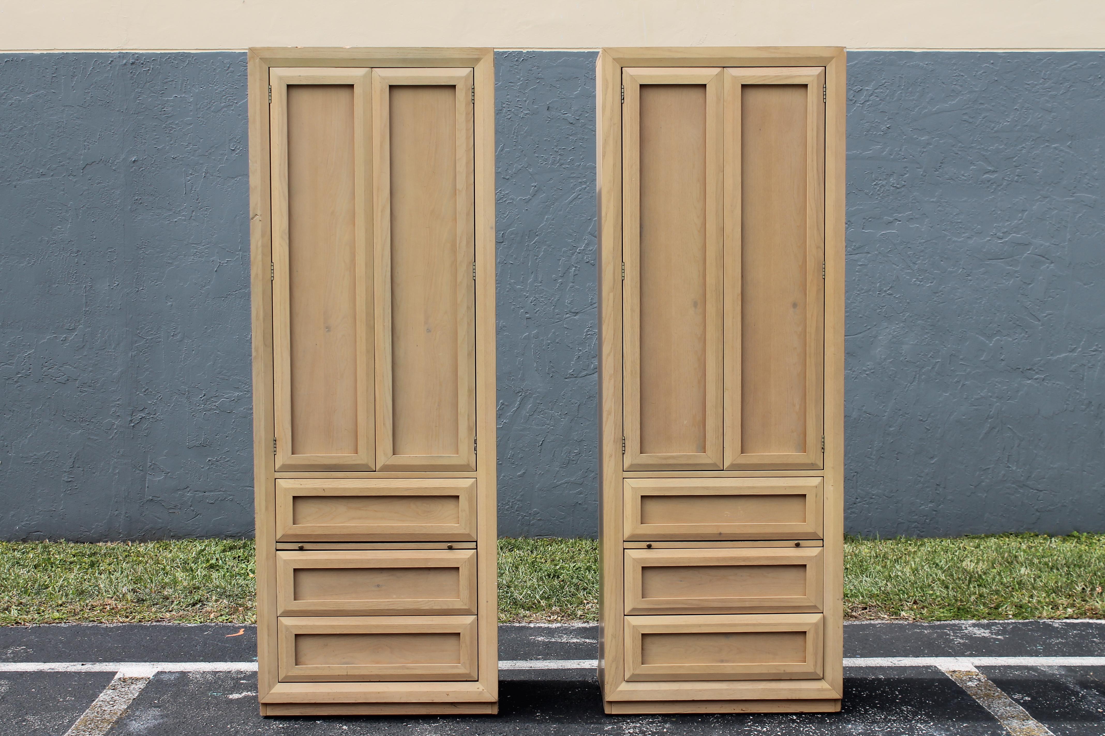 Pair 1970's Tall Light Toned Wood Bed Side Cabinets/ Bachelors Chests. This pair would work very well as Night Stands as well. 3 drawer, 3 shelf and 1 pull out shelf. Great storage. 