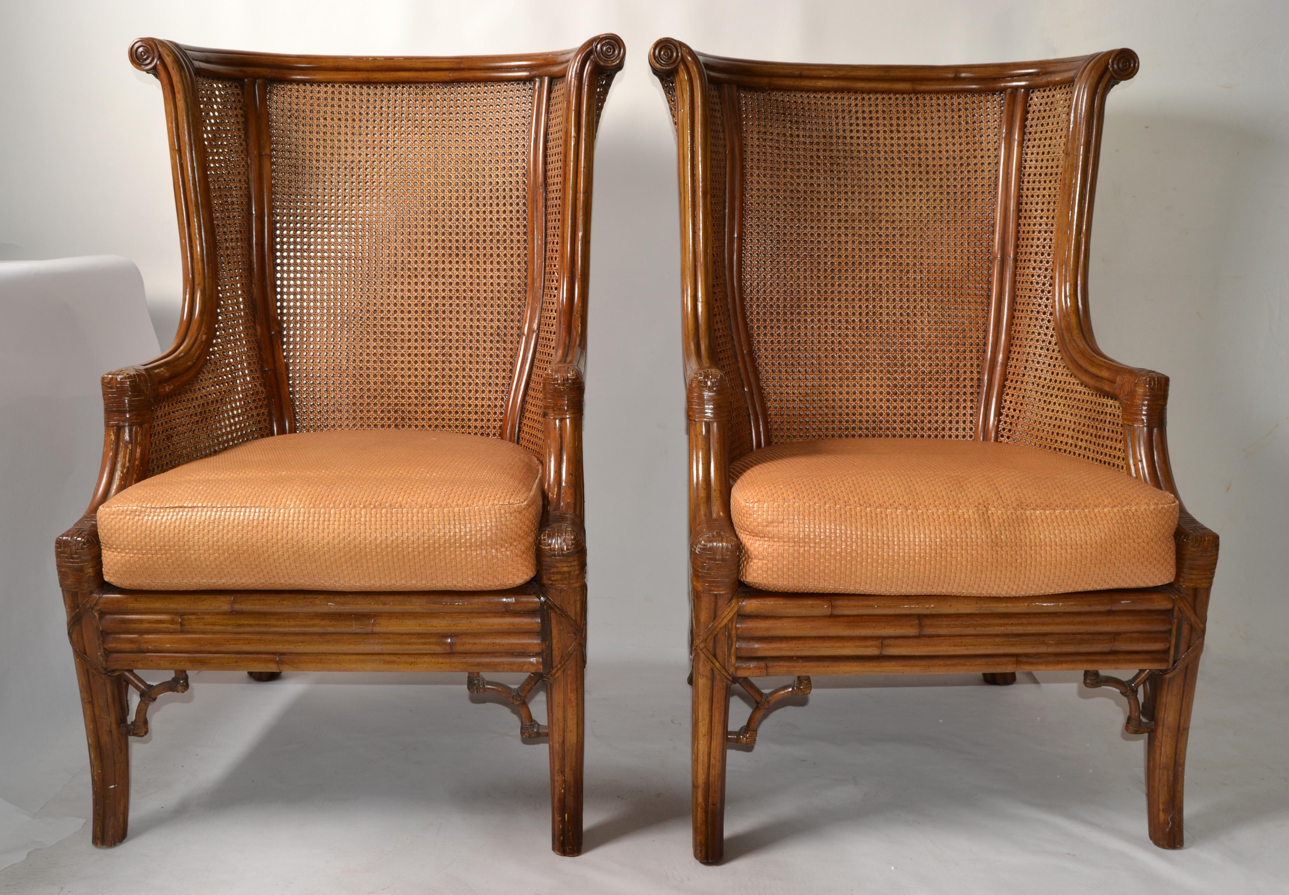 Pair of British Colonial Style Lane Venture Bamboo, Faux Bamboo and handwoven double Caning Wingback Chairs.
Large Lounge Chairs in Bohemian Period Style with a thick Leather Seat Cushion.
Stunning carvings at the Top, very detailed base with Bamboo