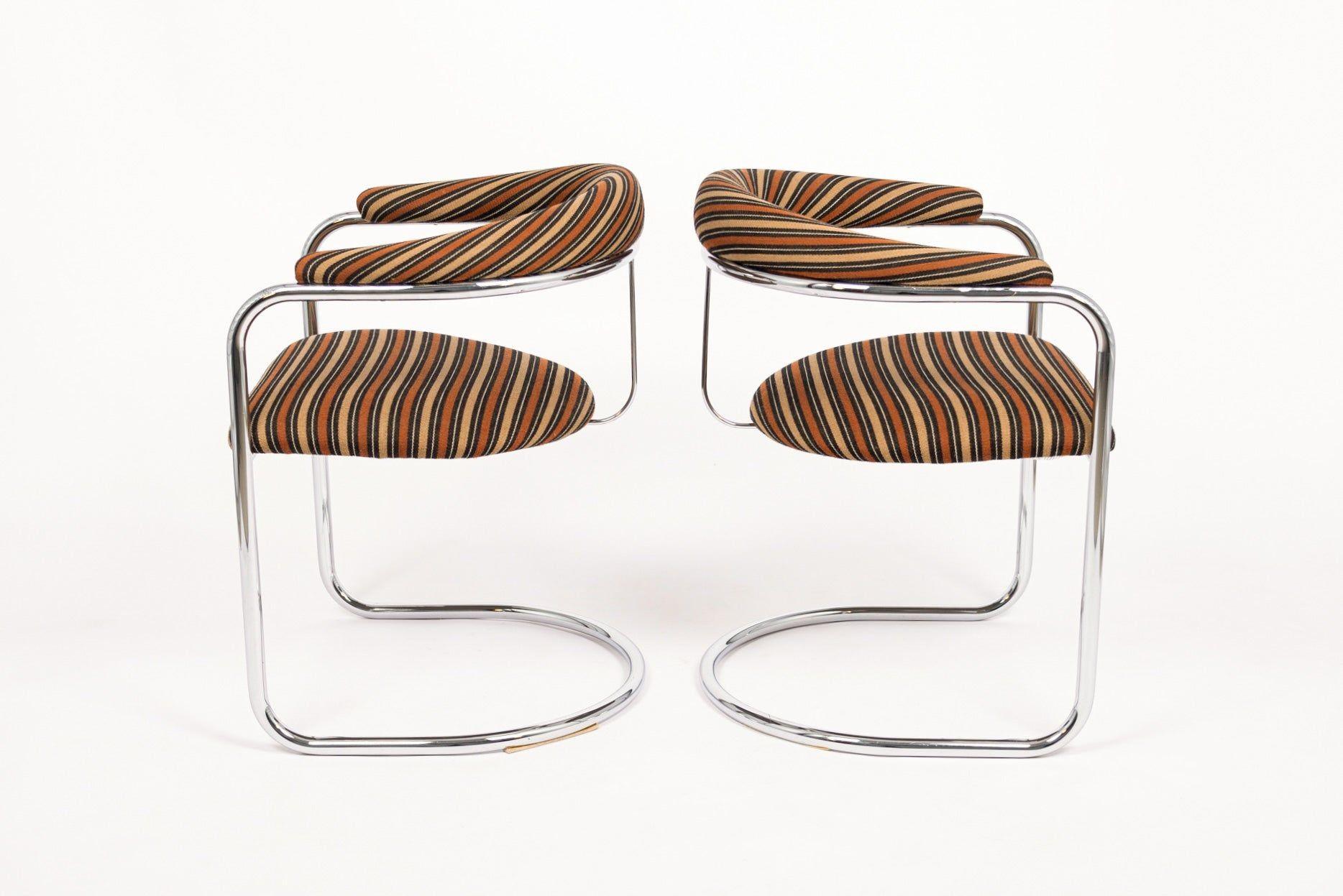 This pair of vintage mid century modern SS33 dining chairs were designed by Anton Lorenz and manufactured by Thonet. These iconic Bauhaus arm chairs feature chrome-plated tubular steel cantilevered frames with striped upholstery fabric on seat and