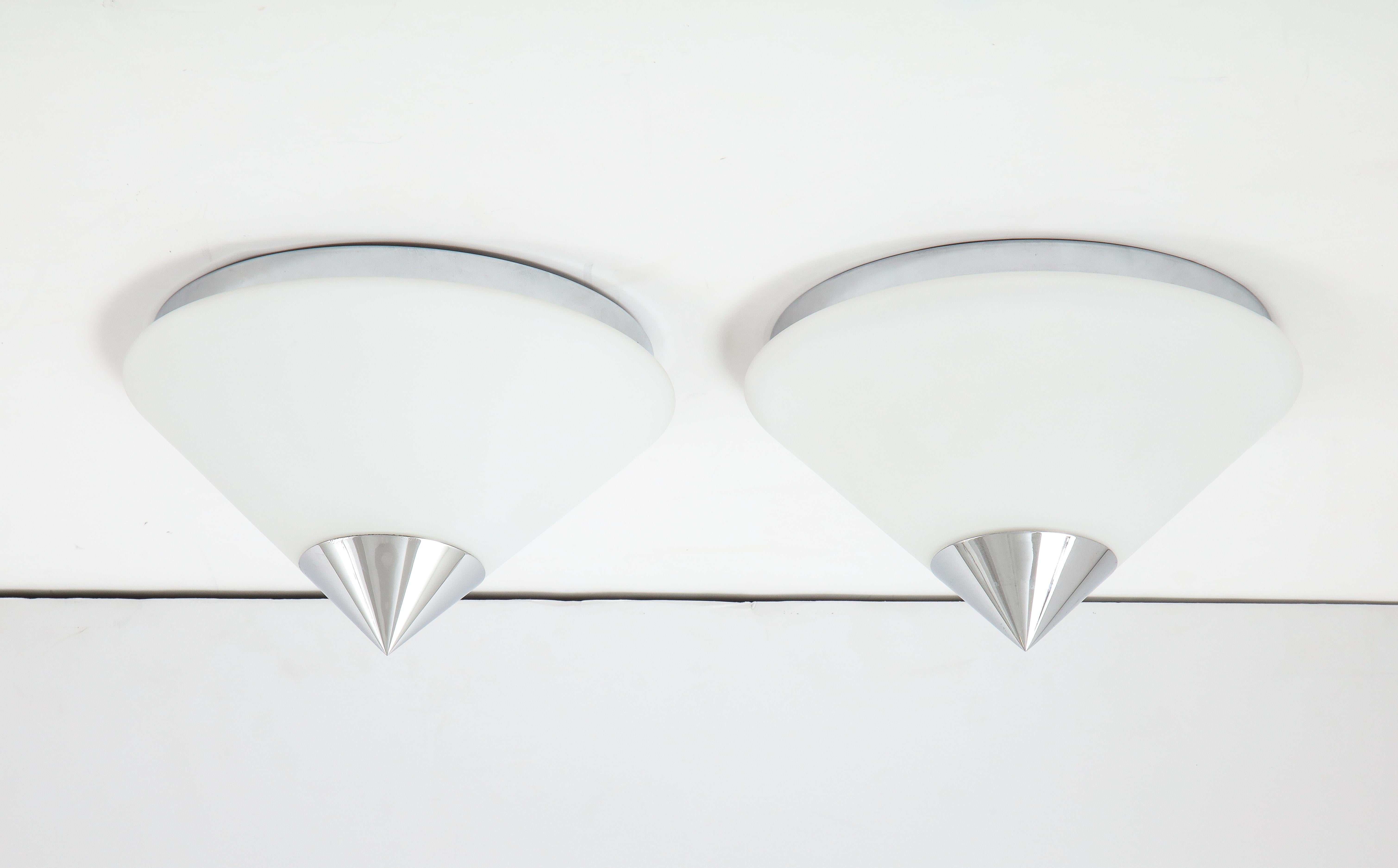 Pair of 1970s midcentury flush mounts /sconces by Limburg.
The large cone shaped Opaline glass shade is finished with a polished chrome cap sits on a
wall plate that has been Newly rewired for the US with a single light source MAX 60 watts.