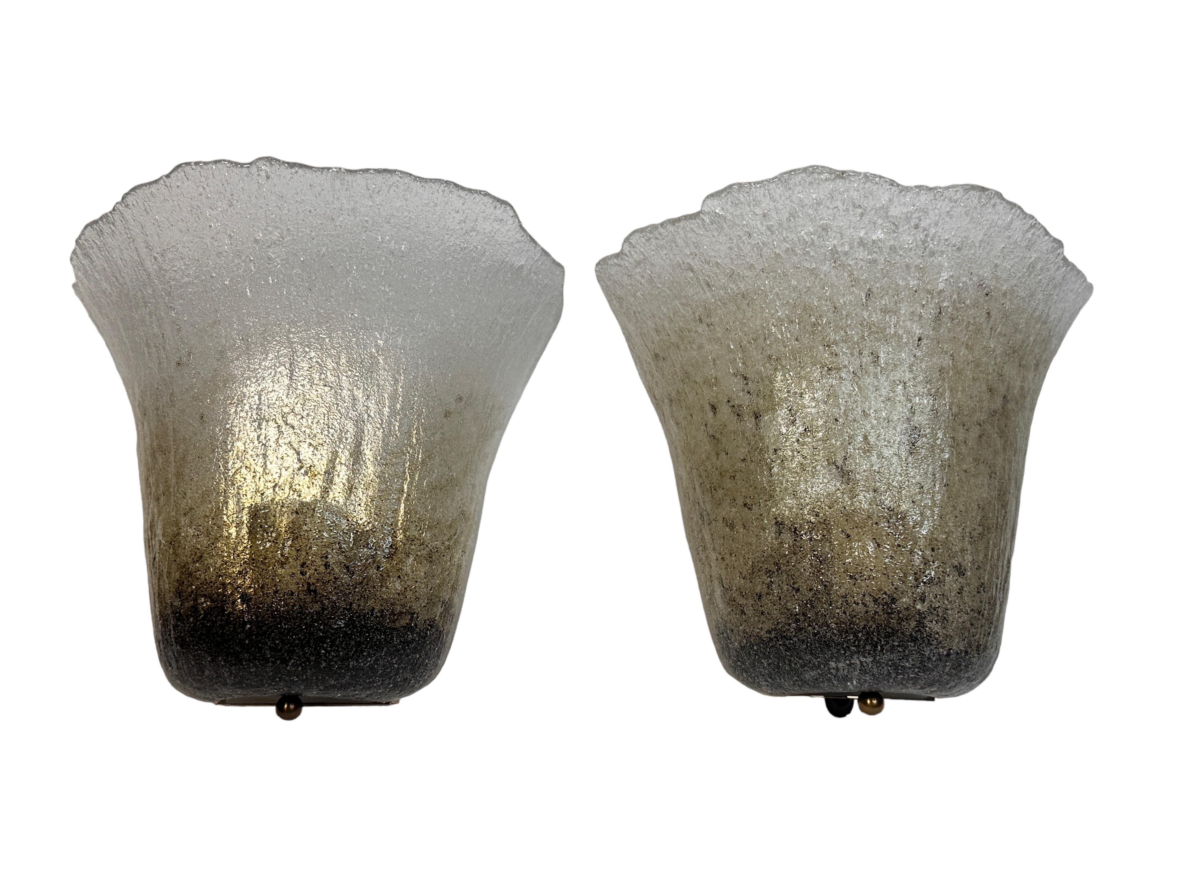 Two beautiful sconces made by Peill and Putzler, circa 1970s, in very good original condition. The heavy Murano glass is composed of a metal frame and with one light. Each Fixture requires one European E27 / 110 Volt Edison bulb, up to 75 watts.