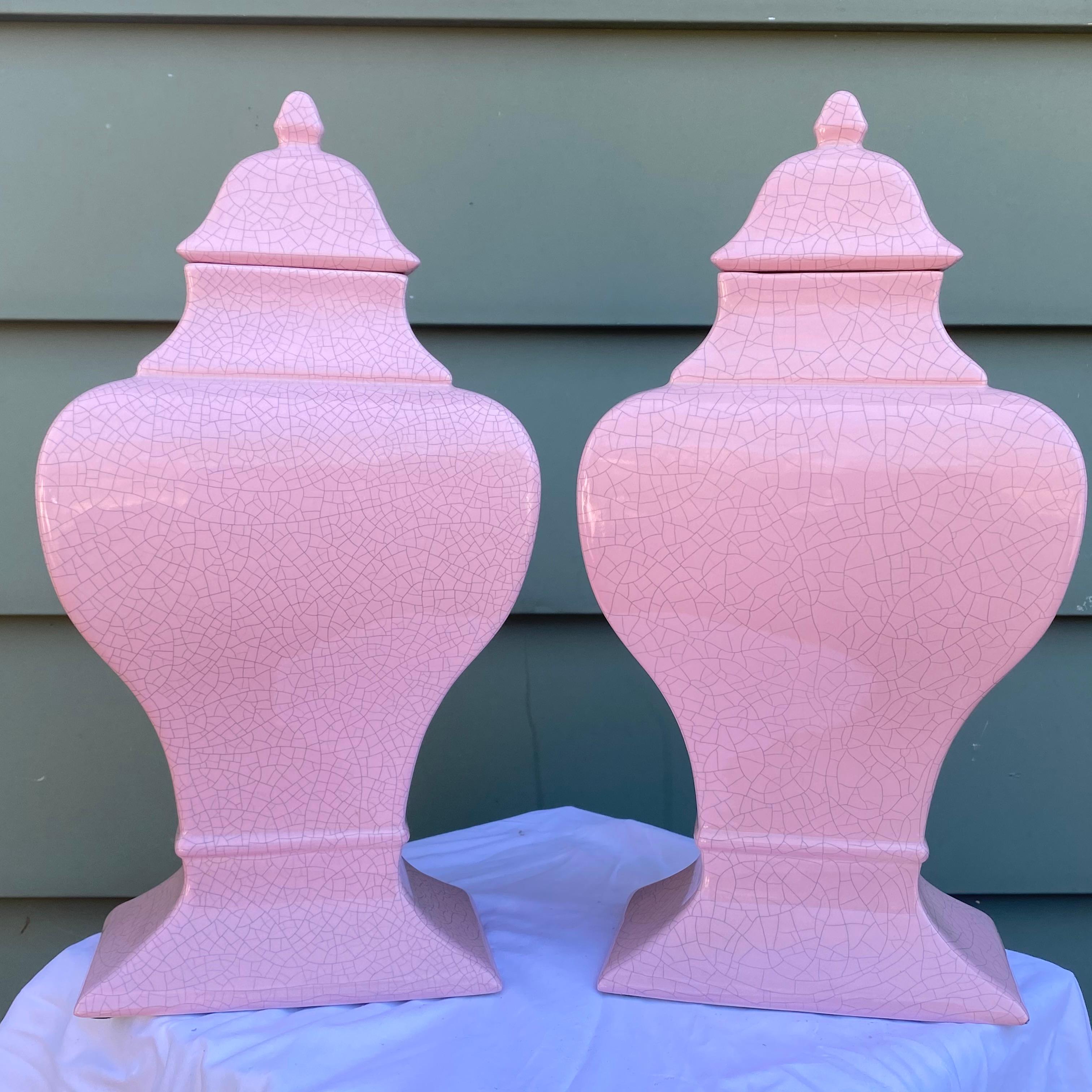 A fantastic pair of artisan made ceramic lidded jars fired in a pink crackle glaze finish by the California pottery company Jaru.