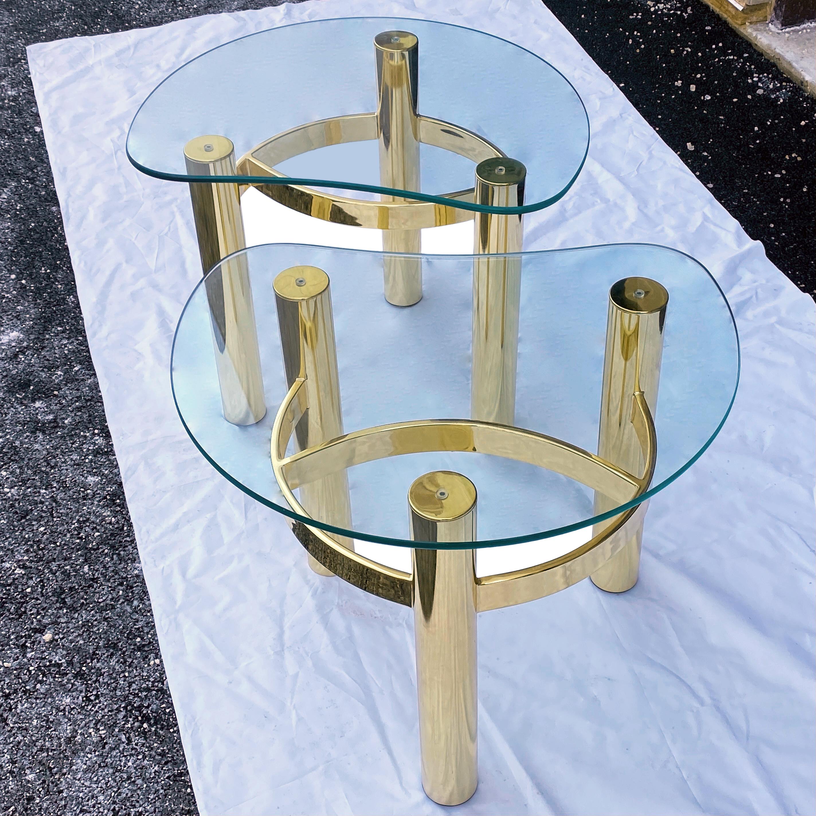Vintage kidney shaped glass side table set on one piece brass finished sculptural base. Circa late 20th century unmarked. 1/2” thick glass tops