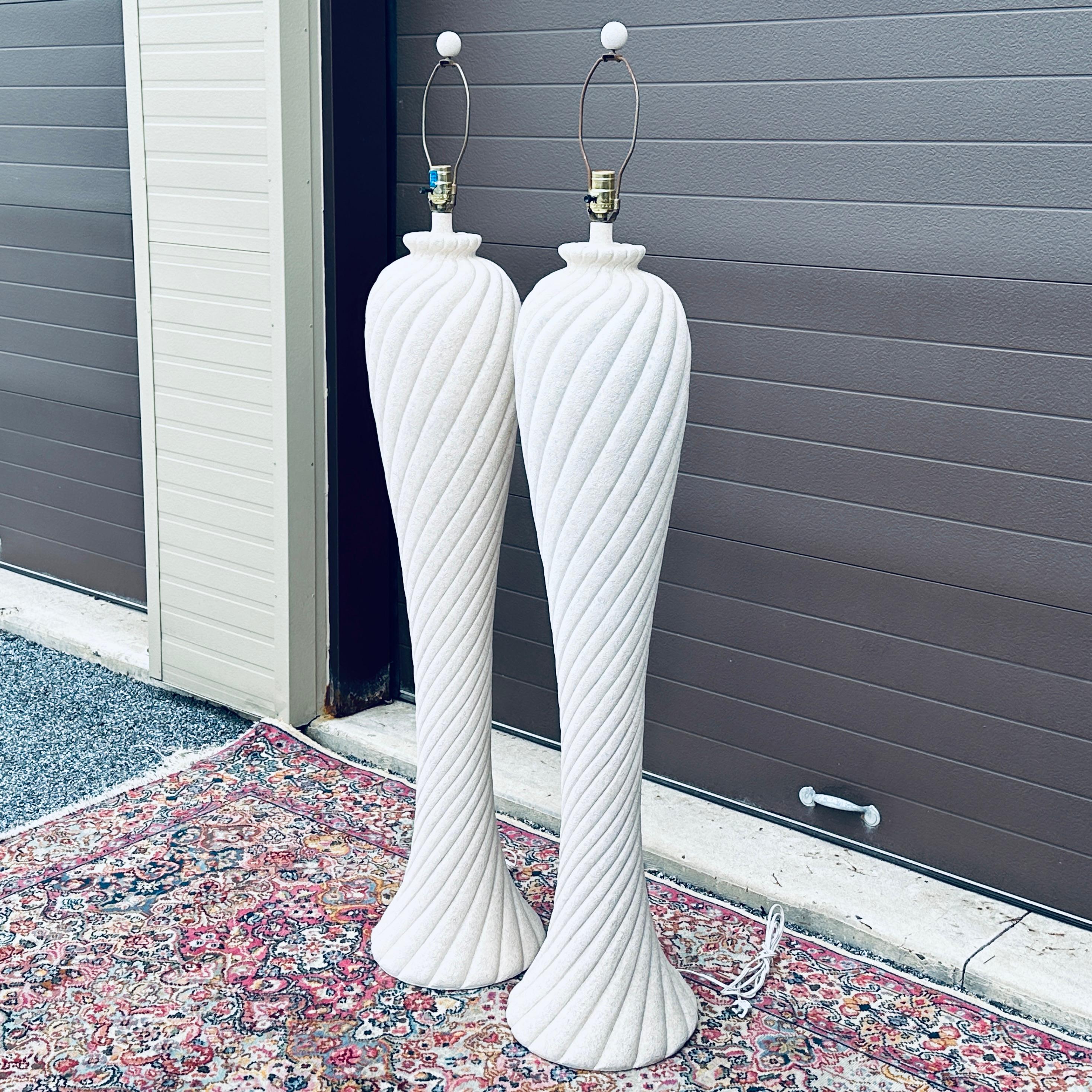 Nice pair of 1980's plaster spiral floor lamps with matching ball finials made by Dynasty in the style of Michael Taylor. The lamps are an antiqued white color with blue and pink splatter finish. Please view the close up photos to see what the