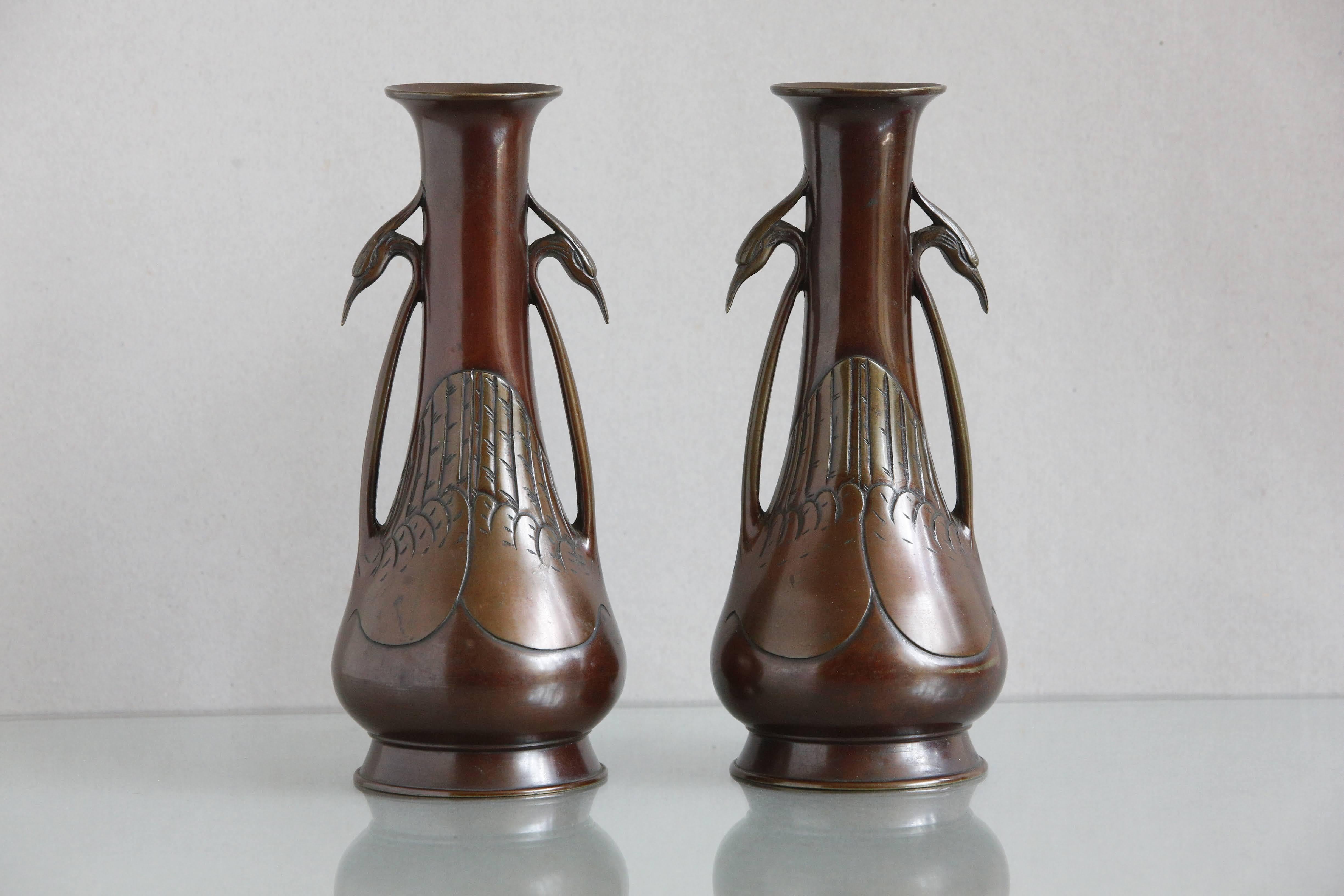 A stylish pair of Japanese vases of the Meiji period with egret handle dual tone decoration.

Some tiny indentations and slight rubbing to extremities.

Condition commensurate with age.

Circa 1890.
   