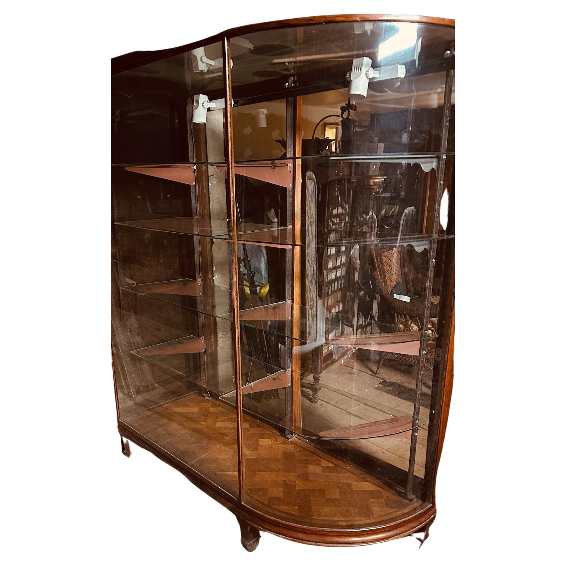 A pair of incredible bow glass sided show cases from one of the exclusive ladies fashion shops in the Newbury Street area of Boston,Ma. These spectacularly designed glass show cases date from the late 19th C. and are handsomely wood trimmed with