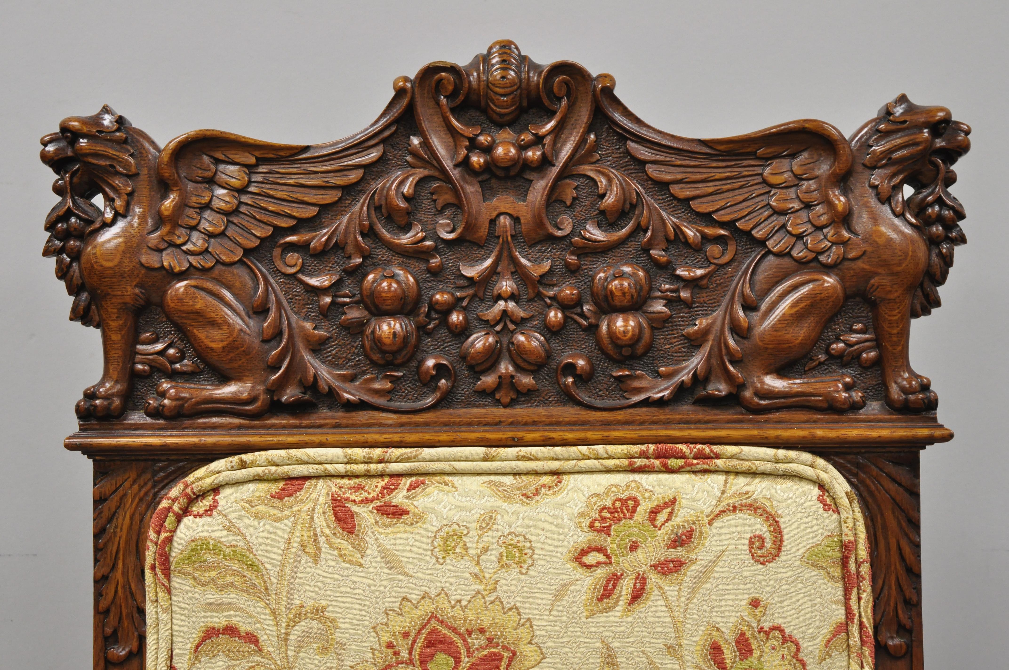Paire de chaises de salle à manger en chêne sculpté du 19e siècle, à pieds ailés Griffin, attribuées à RJ Horner. L'article présente un griffon ailé sculpté et des volutes de récolte sur la traverse supérieure, un dossier et des sièges rembourrés,