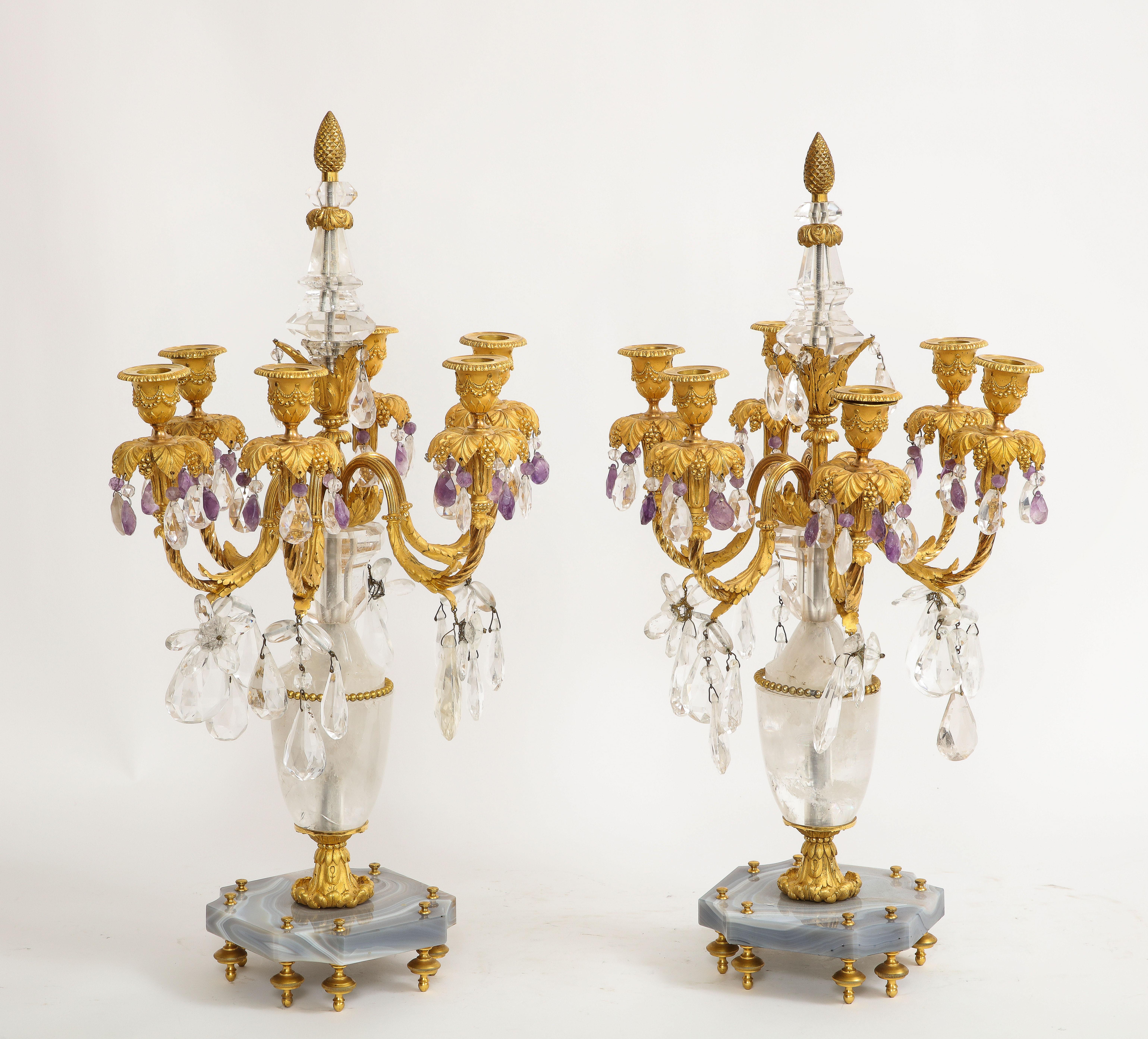 A magnificent pair of 19th Century Louis XVI Style French dore bronze mounted hand carved agate, rock crystal, and amethyst candelabra. The dore bronze mounts are truly impressive on this pair of candelabra. Each section of the mounts are