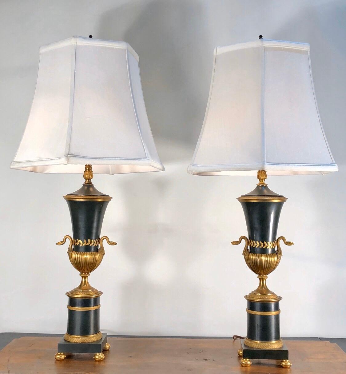 Magnificent pair of early 19th century French Empire urns with ormolu-mounts converted to lamps. These Period Empire table lamps have the original gilt and patinated bronze finish. The ormolu-mounts are of the highest quality with the finest
