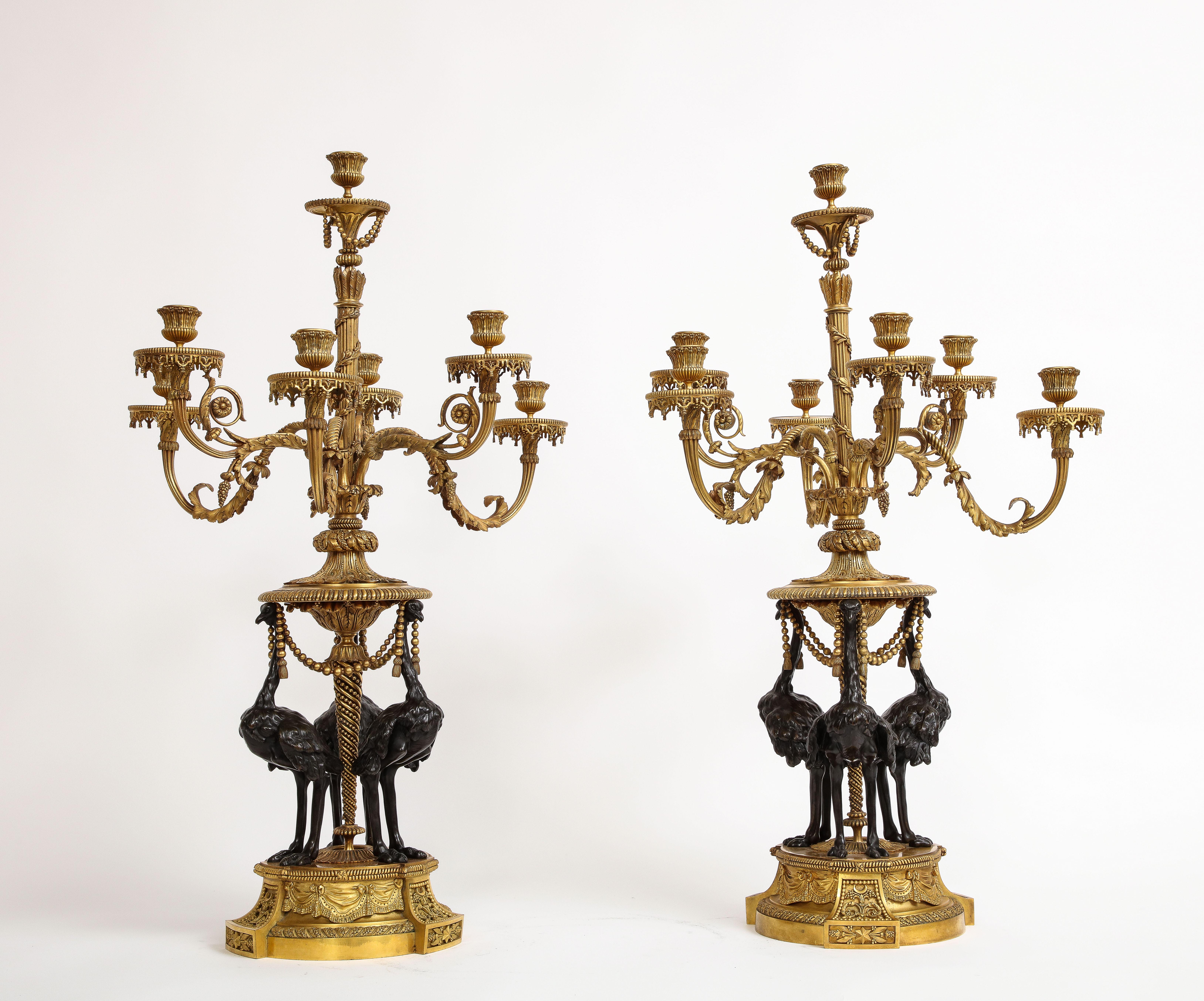 An Extremally Rare and Large Pair of 19th Century French Louis XVI Style Ormolu and Patinated Bronze Seven-Arm Candelabra, by Alfred Beurdeley, Originally Designed by François Rémond. These extraordinary pieces serve as a testament to the epitome of