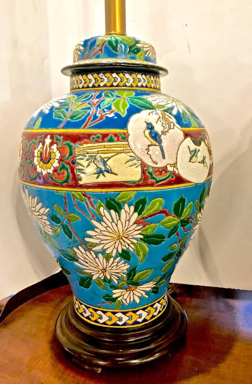 This is a unique pair of French 19th c. Longwy majolica covered jars that have been fitted as lamps. The majolica dates to the late 19th c. Aesthetic Movement period and are in a stunning shade of blue with incised chrysanthemums, reserves of birds