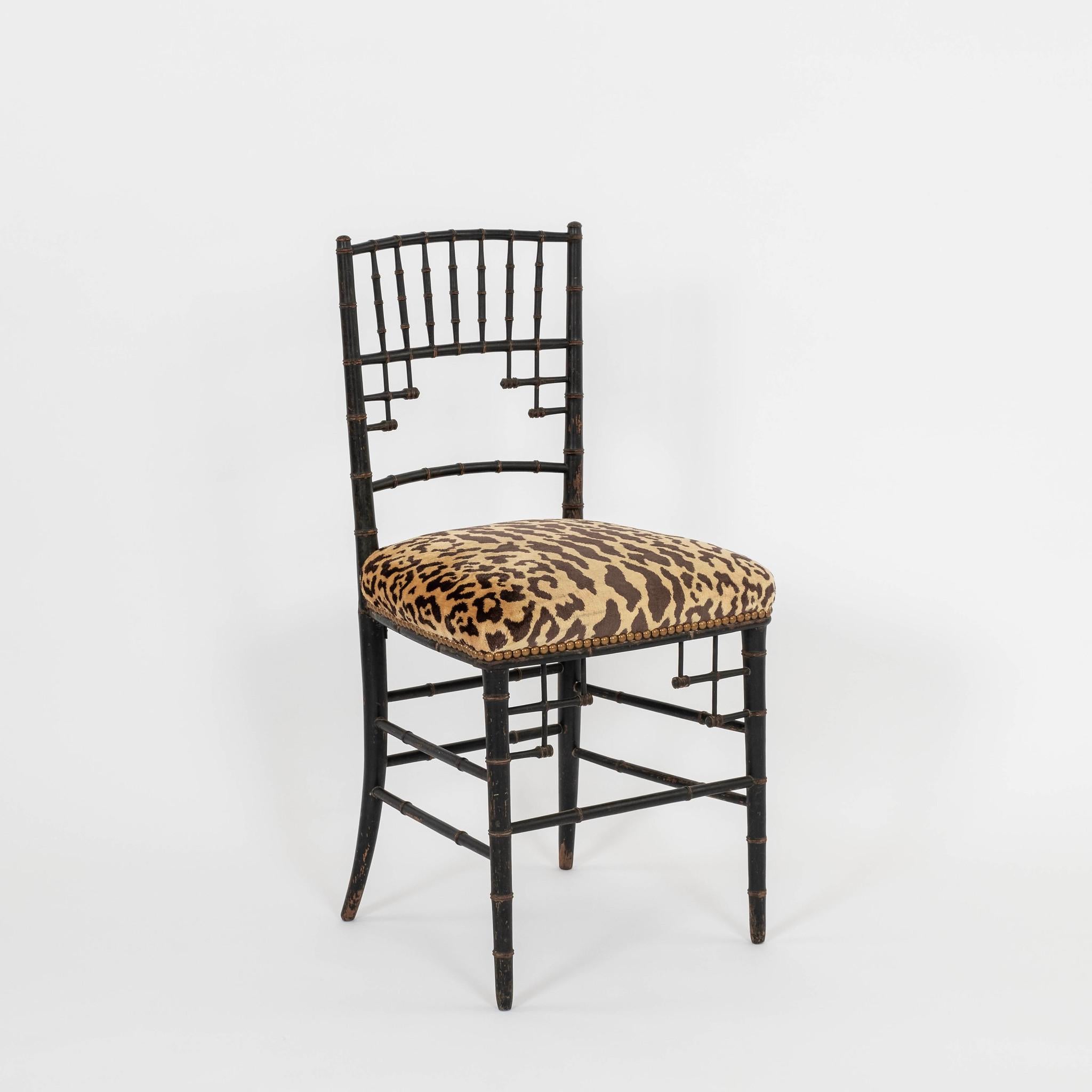 Exquisitely hand turned and carved period Napoleon III faux bamboo opera chairs upholstered in Leopardo silk velvet.