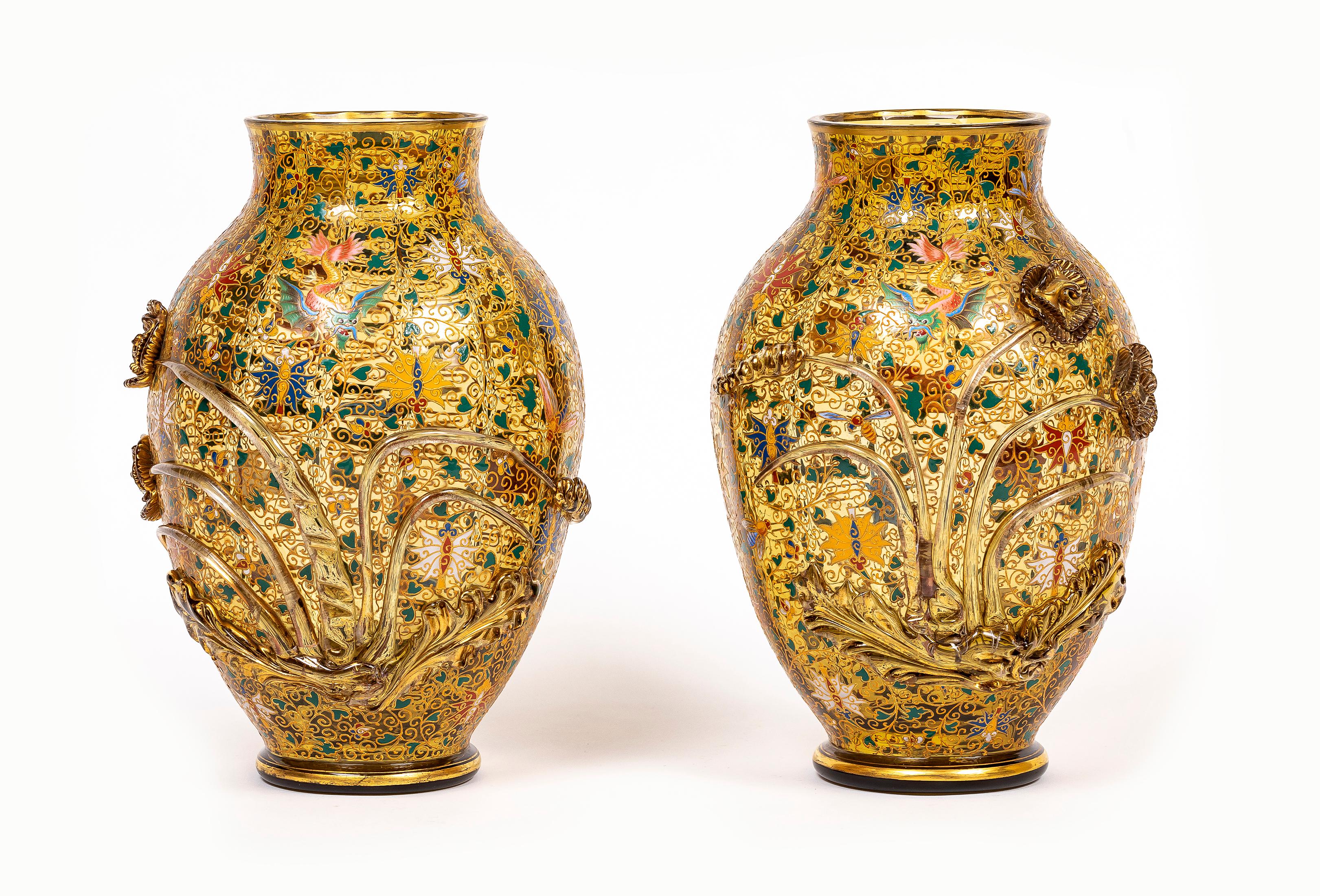 Una fantastica e rarissima coppia di vasi in cristallo di Moser del XIX secolo con decorazioni smaltate e dorate a mano.  Ciascuna di forma ovale, in vetro ambrato traslucido, con ramo e fiori applicati, e decorata in stile cloisonné con vite e
