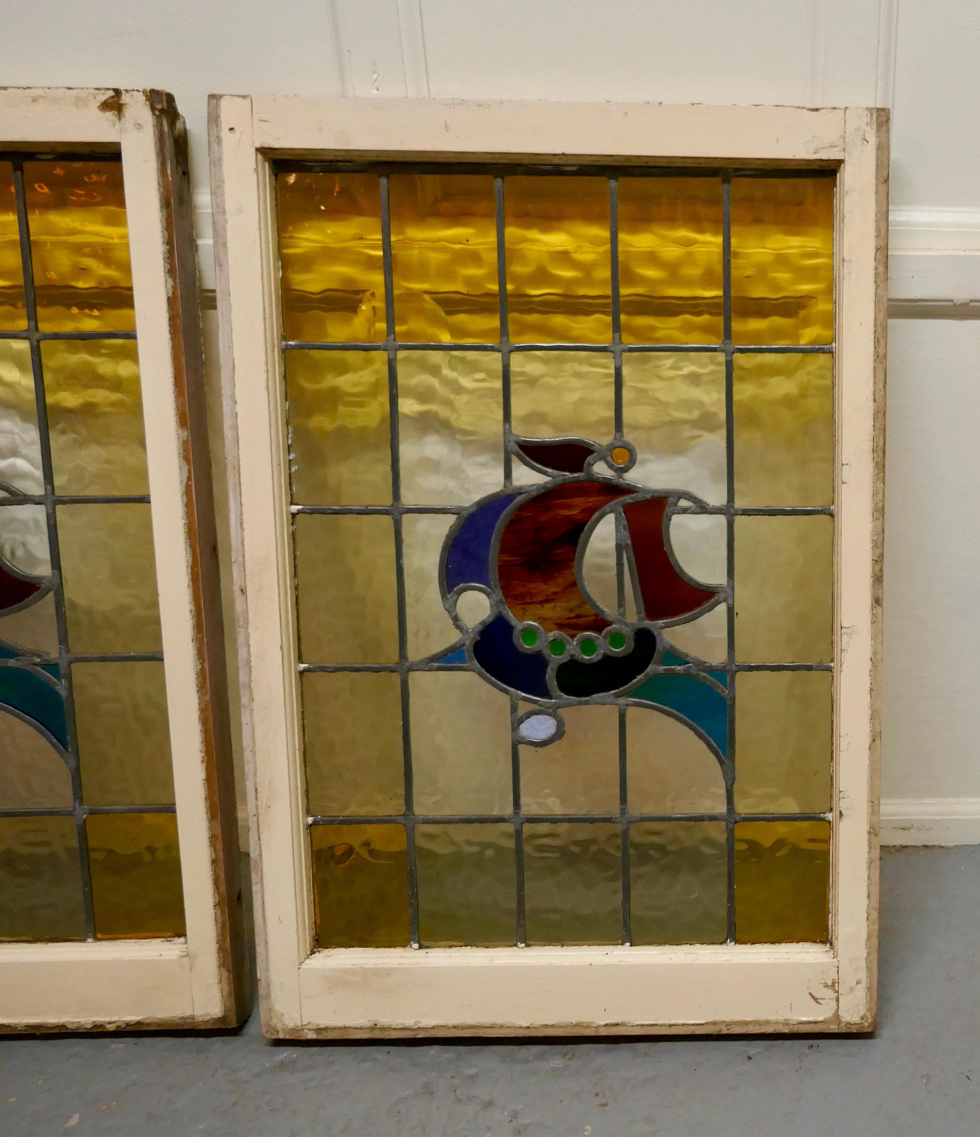 Pair of 19th century Art Nouveau stained glass windows, with ships

These are a pretty and very colorful Art Nouveau style windows, both jewelled and stained glass
The windows are in their original frames these are is in their old cream