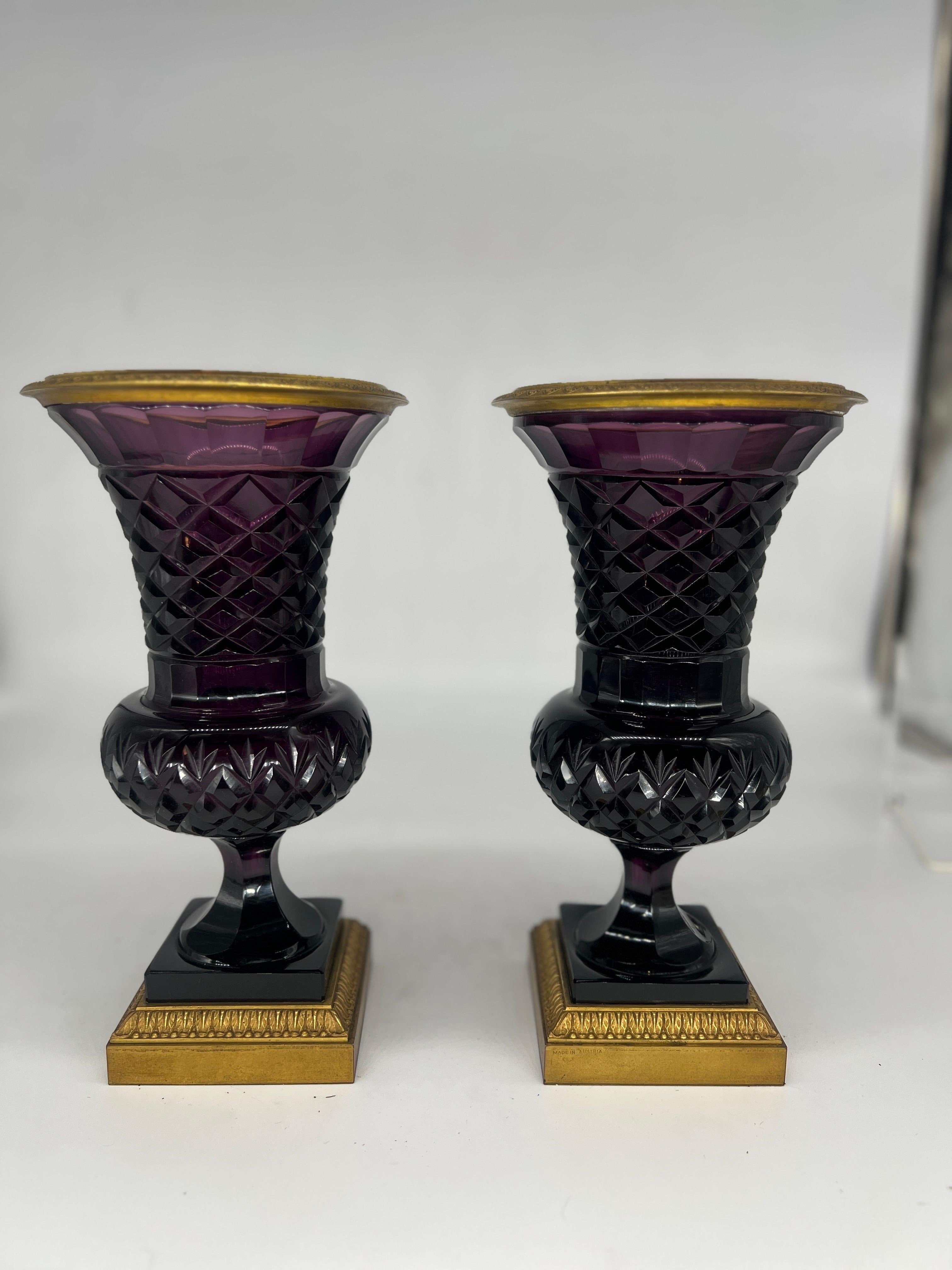 An incredibly fine pair of antique Amethyst cut crystal vases mounted with dore bronze mounts. The vases have delicate faceted detail reminiscent of the Baccarat firm in France which likely supplied these vases. The base is marked 