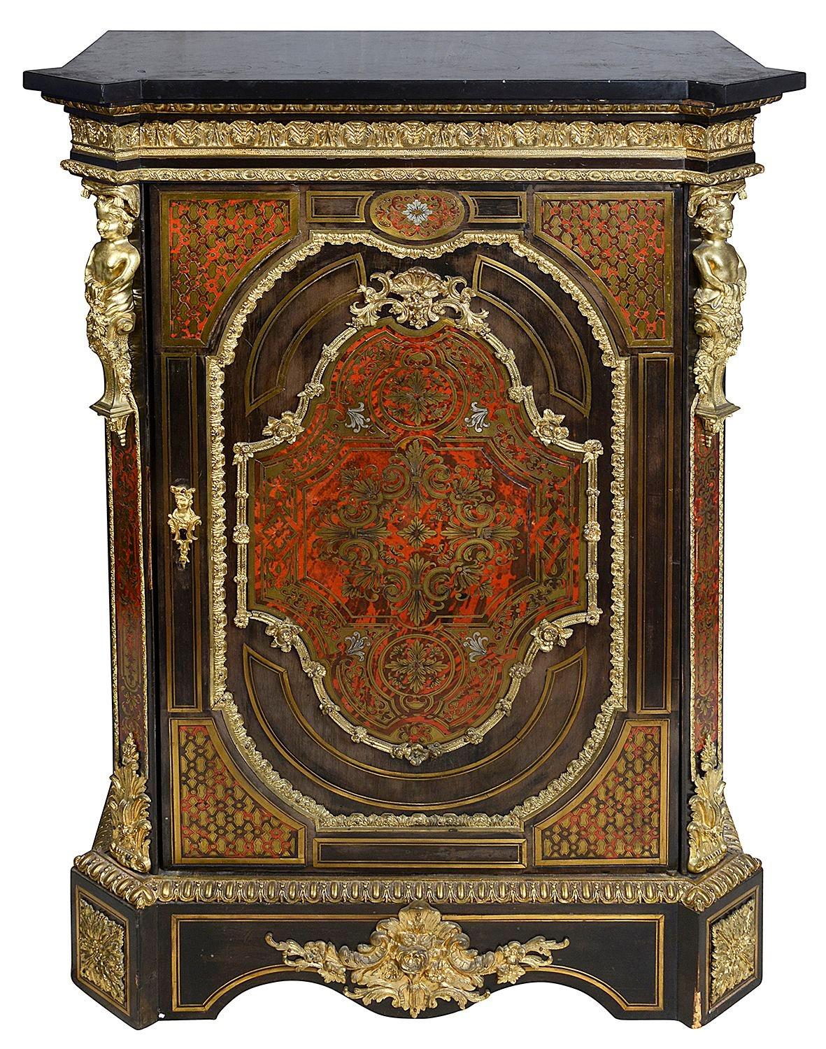 Pair of French 19th Century Boulle inlaid side cabinets, each with their original black Belgium marble tops, gilded classical ormolu mouldings and mounts, canted corners with classical monopodia mounts, red tortoiseshell inlaid panels to the single