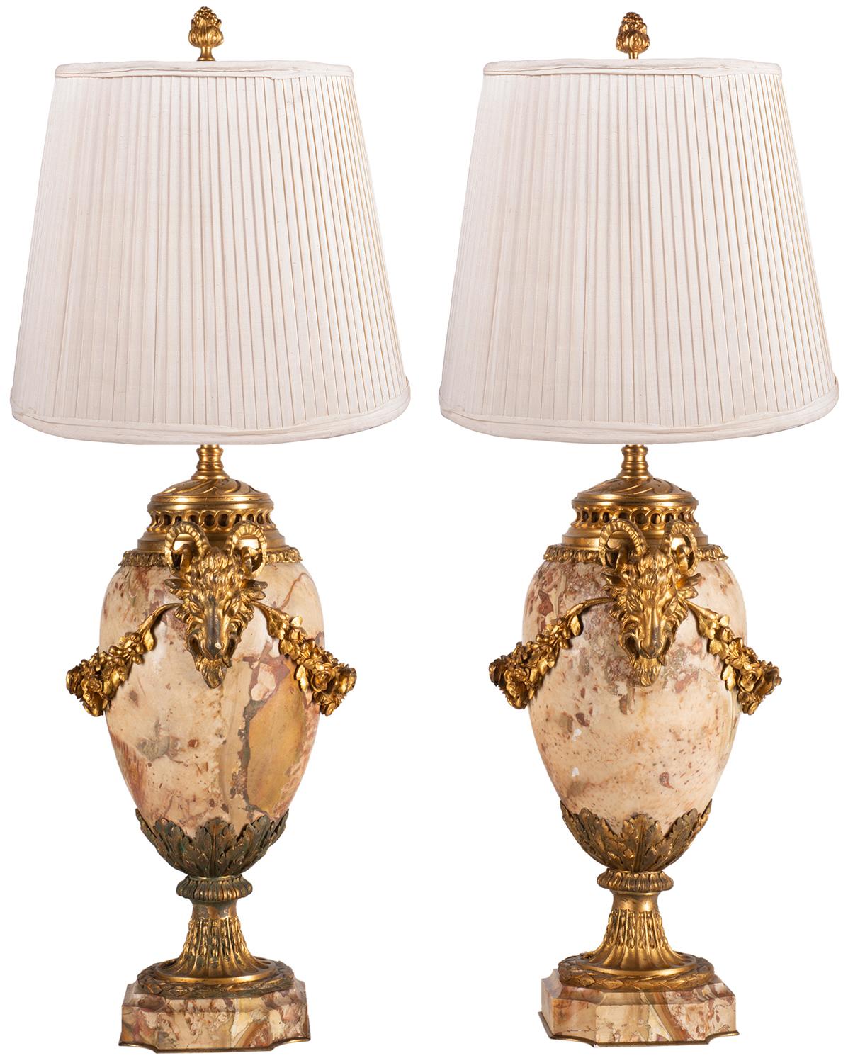 A good quality pair of late 19th century French Breccia marble and gilded ormolu urns / lamps. Each with classical ram's head mounts with floral garlands between, petaled and stop fluted mounts to the square 
re-entrant bases.