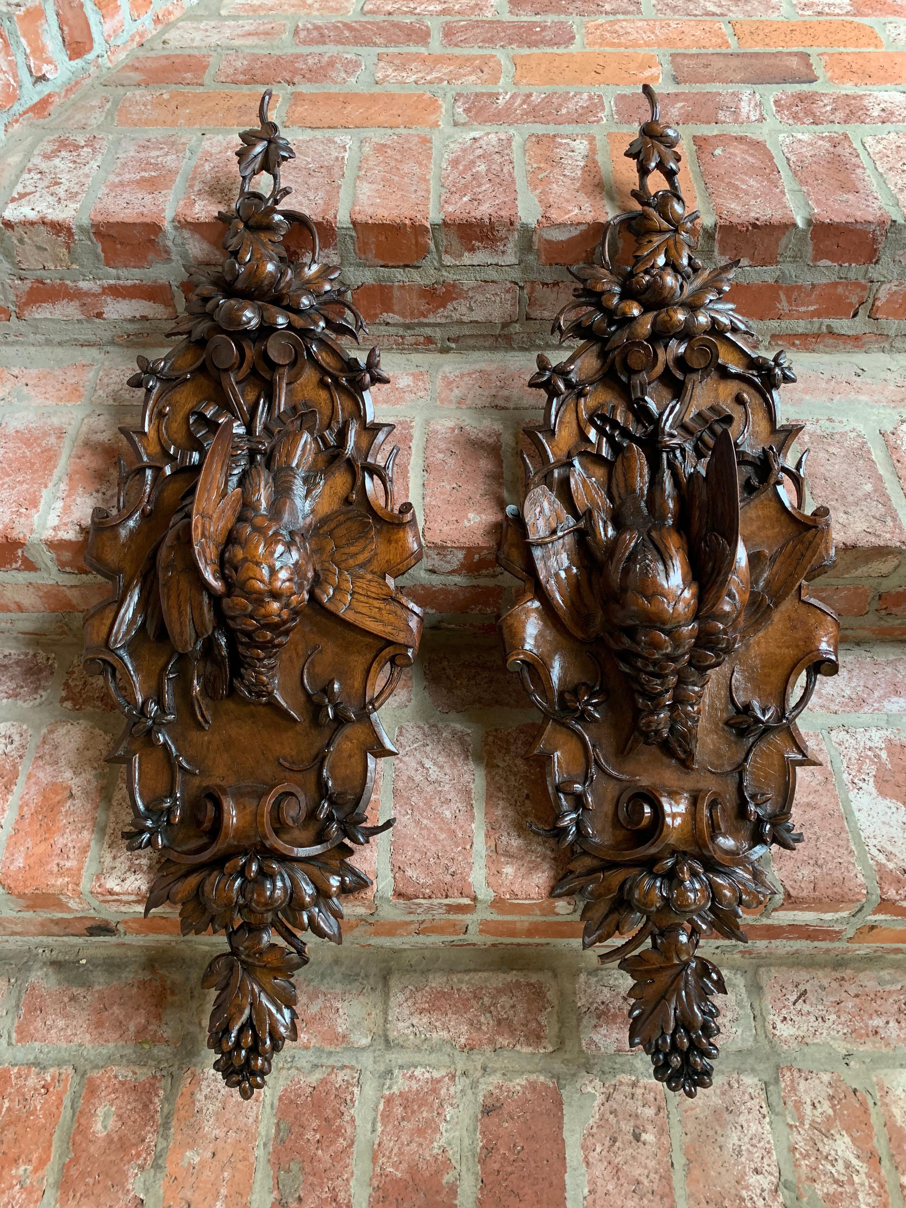 Pair 19th century antique carved Black Forest game trophy wall plaque swiss pheasants

A stunning matched pair of large Black Forest hanging game plaques. 
Beautifully detailed openwork begins at the crown, with intertwined vines having large leaves