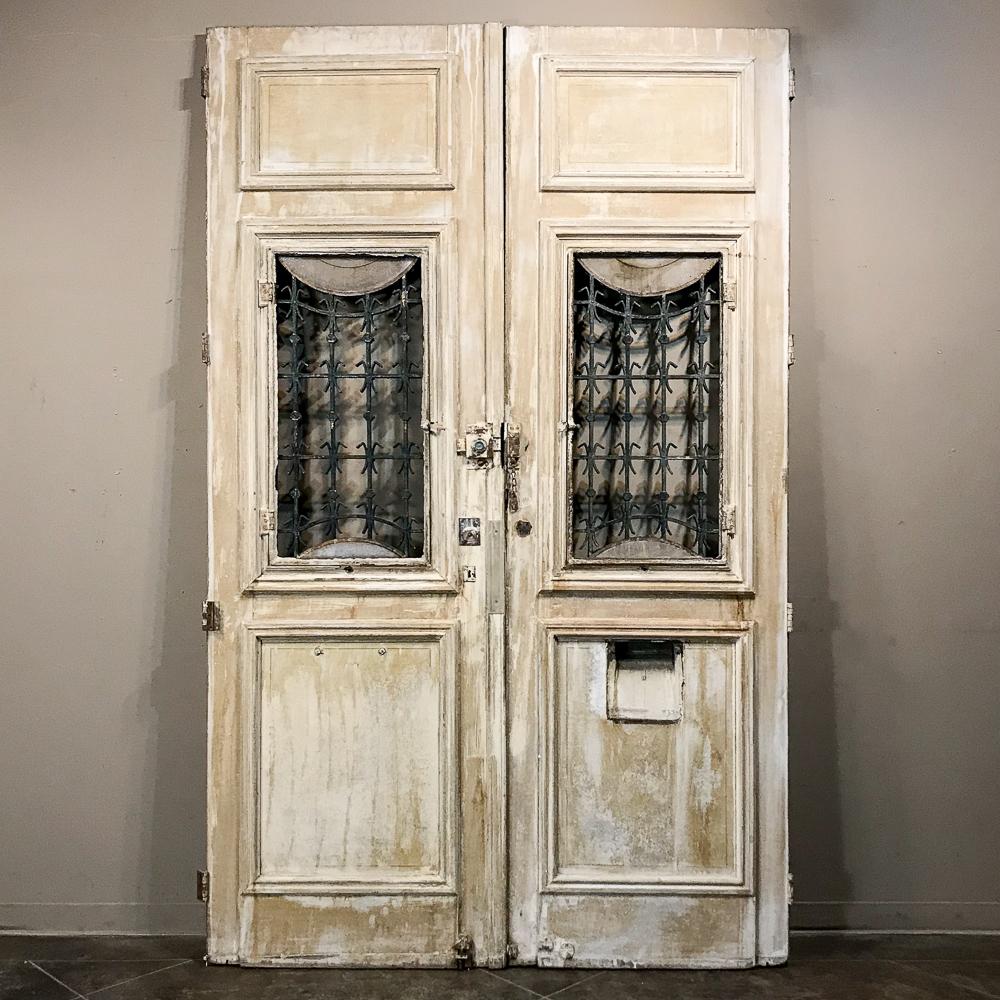 Pair of 19th Century Carved and Stripped Oak Doors with Wrought Iron In Good Condition In Dallas, TX