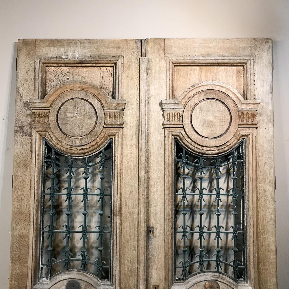 Late 19th Century Pair of 19th Century Carved and Stripped Oak Doors with Wrought Iron