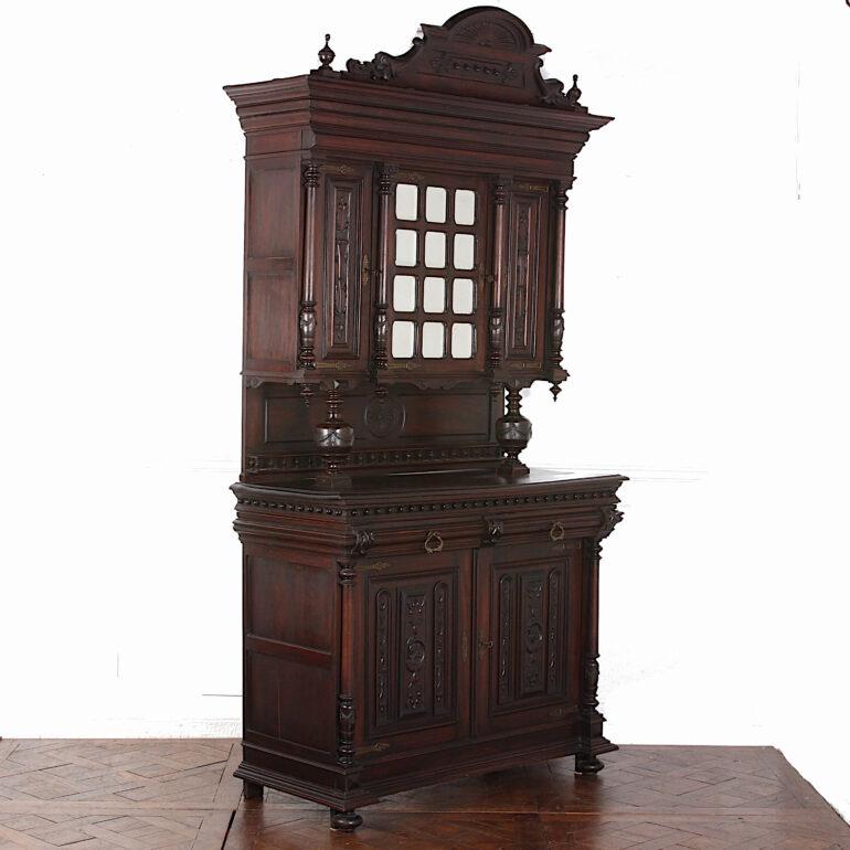 Pair of late 19th century Belgian carved buffet hutches in walnut, the tops with a centre door with beveled mirrors flanked by two narrower carved doors, the base with carved paneled doors, both pieces with architectural details- columns, pilasters,