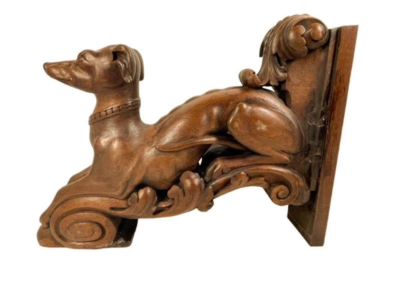 Finely carved pair of 19th century Italian walnut figures of recumbent whippets on foliate brackets, each facing forward with head raised and wearing a collar.
The fully carved three dimensional figures likely decorative architectural elements now