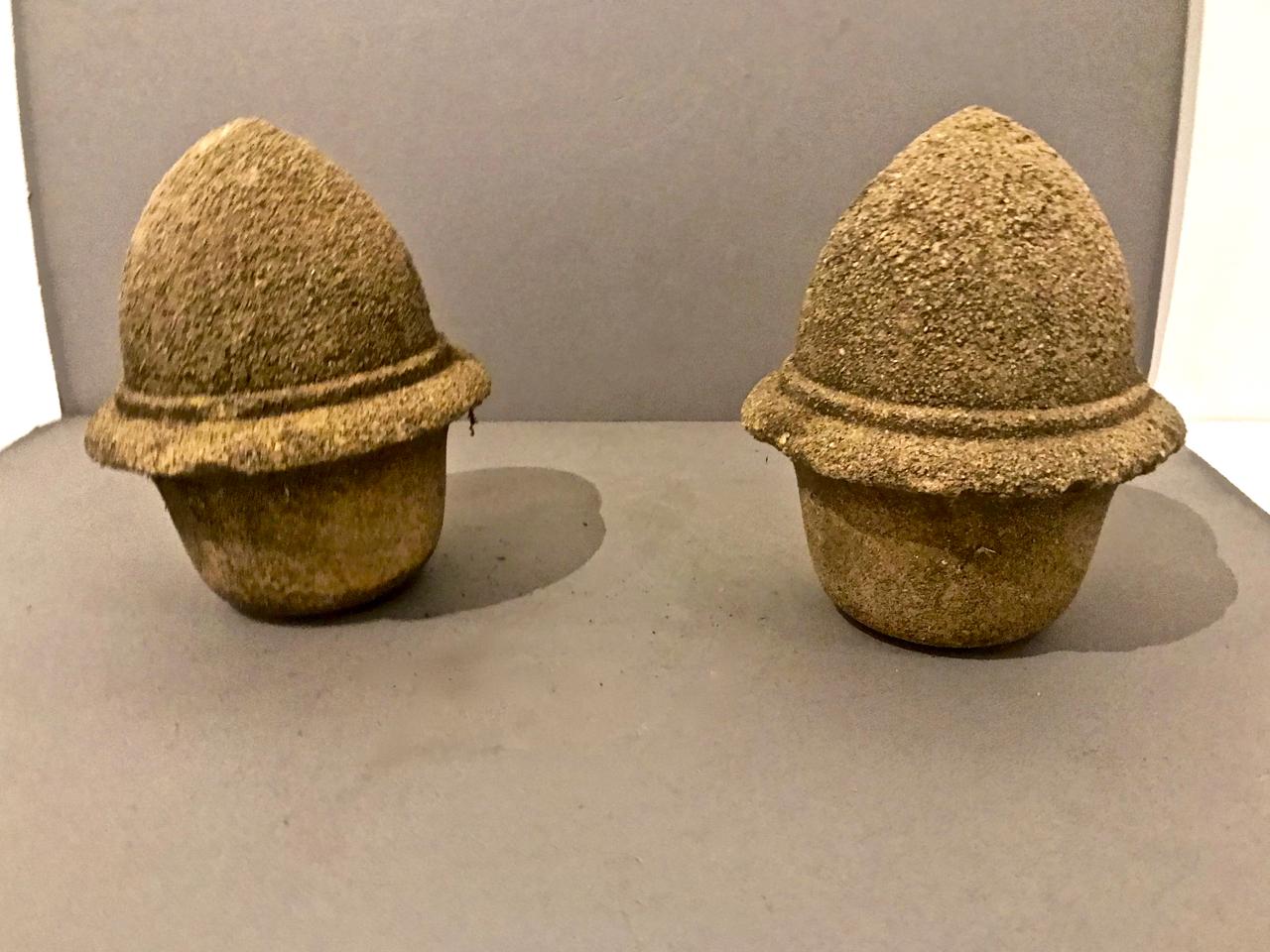 This is a very decorative pair of antique 19th century cement garden finials in the form of acorns. The degraded cement surface gives these guys lots of interest and character. They are great decorative elements inside or out.
