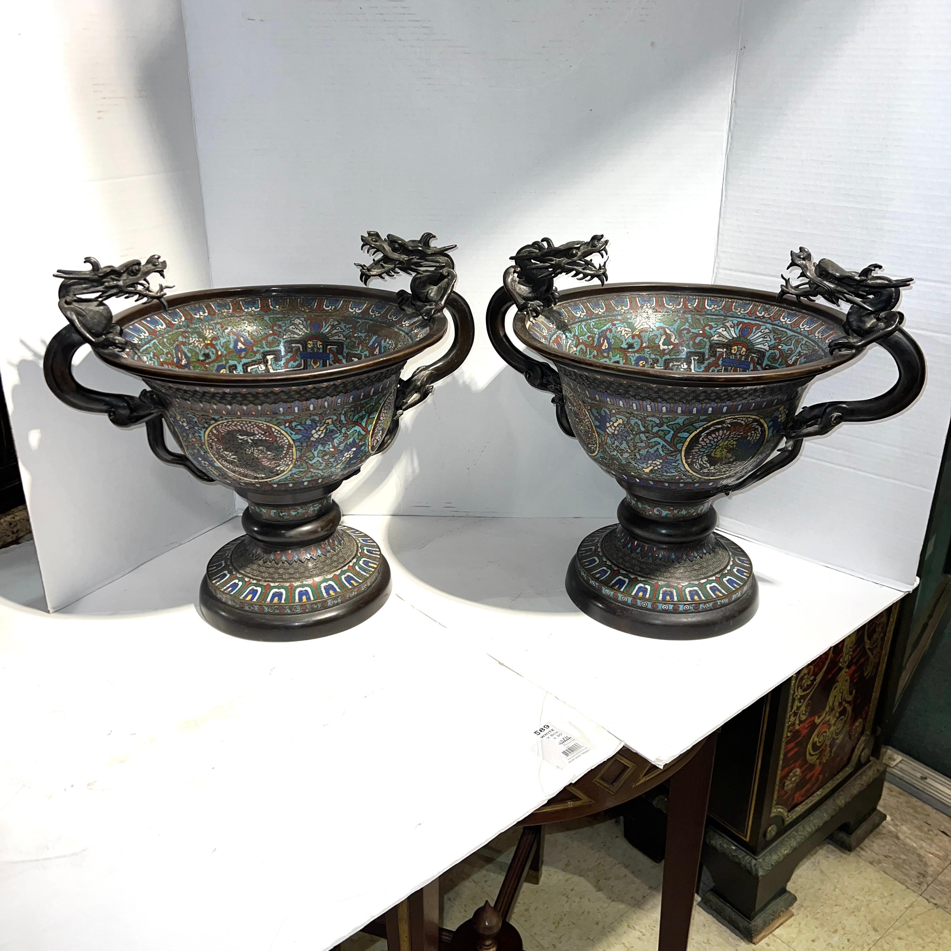 Pair of impressive, large antique (19th century) Chinese centerpiece bowls in the archaic style with prominent dragon form handles and champleve enamel designs.  18 inches across and 14 3/8 inches tall.