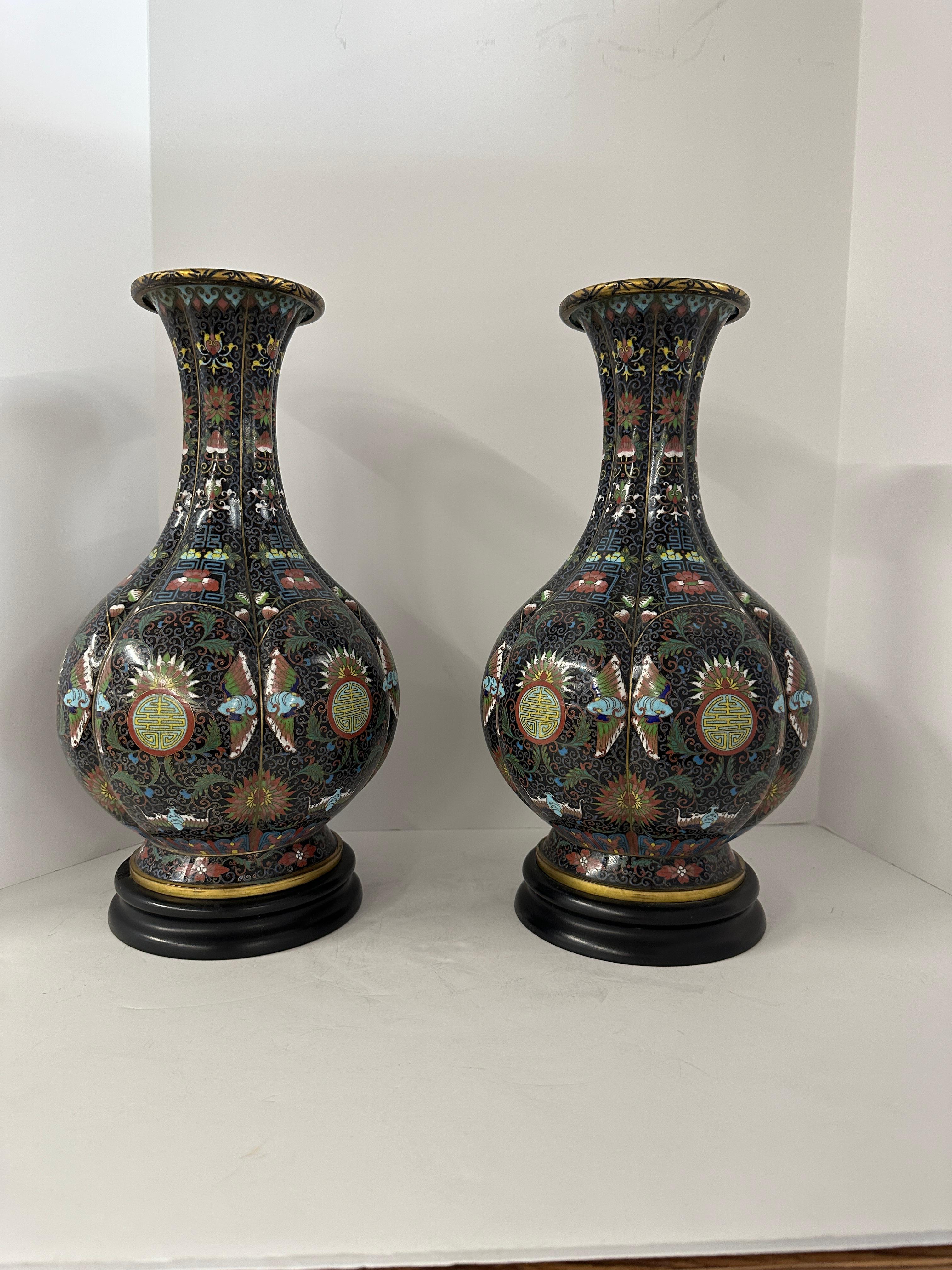 A lovely pair of Chinese Cloisonné vases that are identified as 19th century with an old antique shop tag on the bottoms. We acquire these out of a beautiful Palm Springs Estate and they were configure as lamps. The original wiring  and fixtures