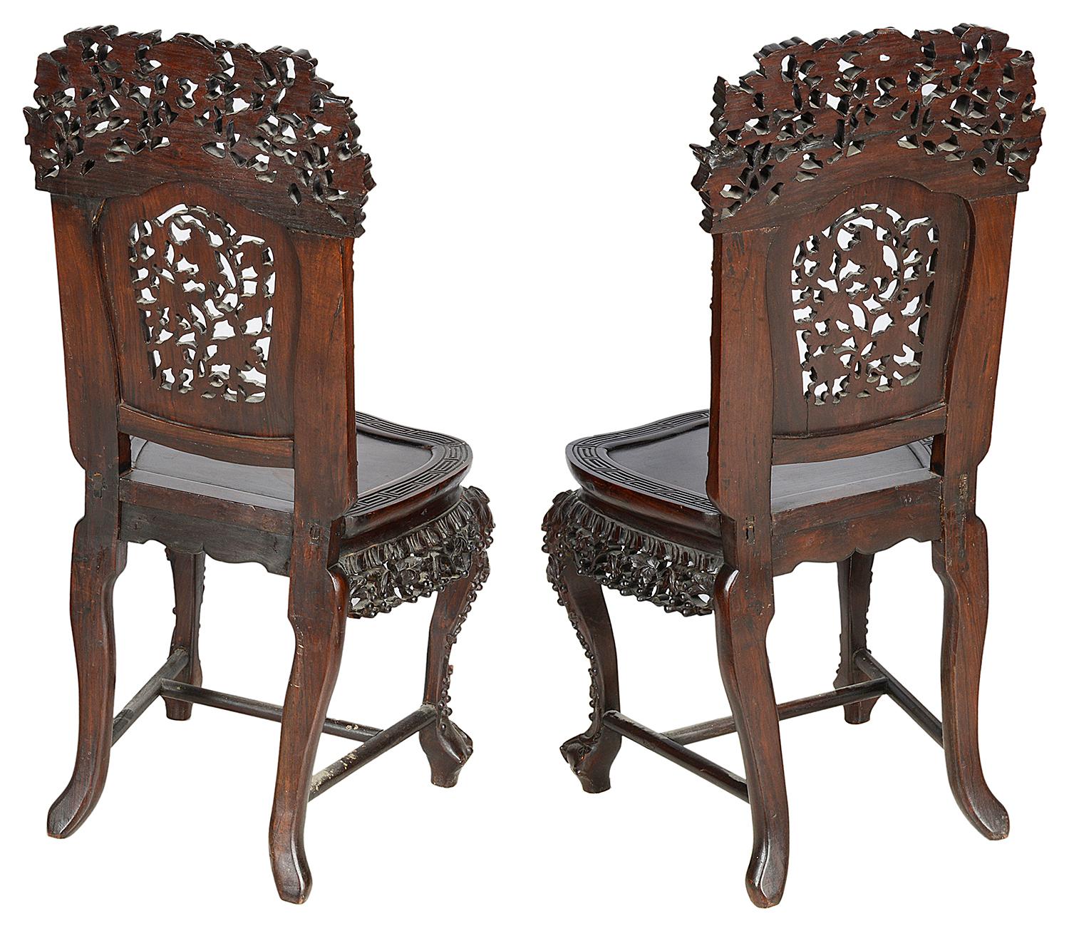 A good quality pair of Meiji Period Chinese hardwood side chairs, each with wonderful carved vine leaf decoration to the backs and bases, with an inset panel to the seat and raised on cabriole legs united by an H-stretcher.